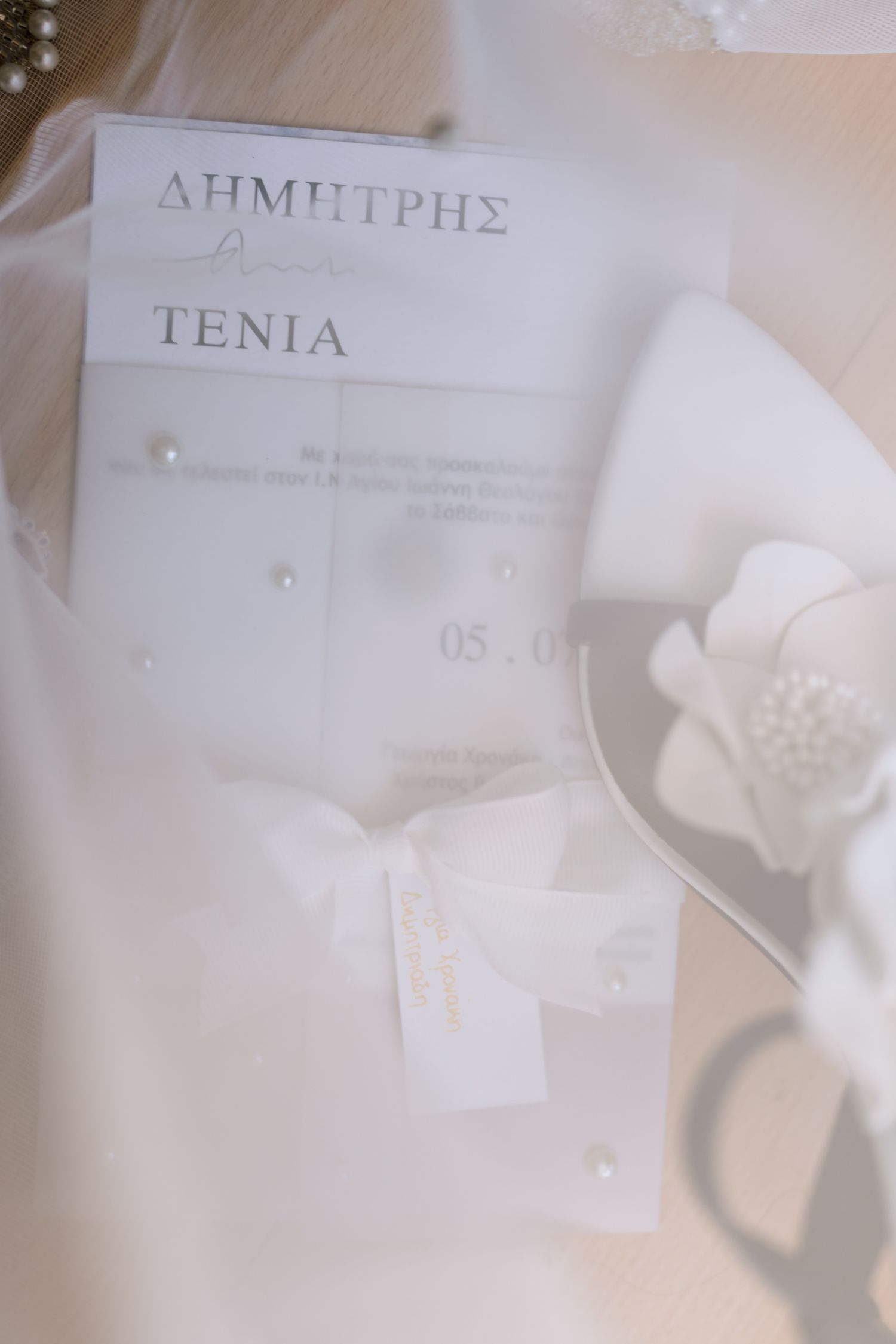 Elegant wedding invitation card with delicate floral details in soft focus.