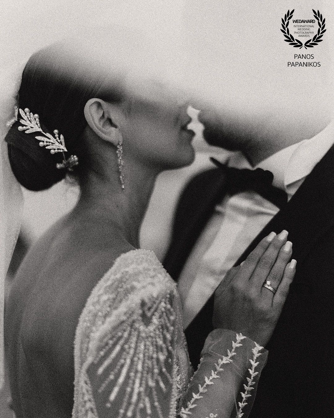 Artistic black and white close-up of bride with delicate jewelry and lace details.