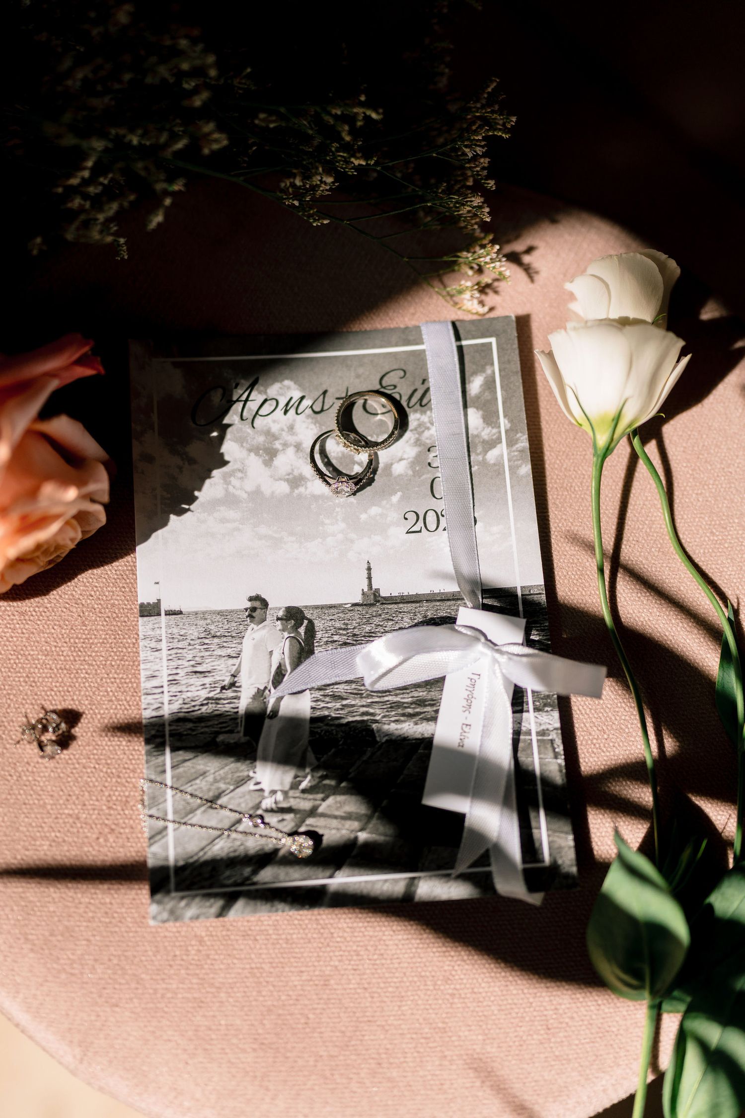 Vintage black and white photos arranged with plant shadows creating artistic composition.