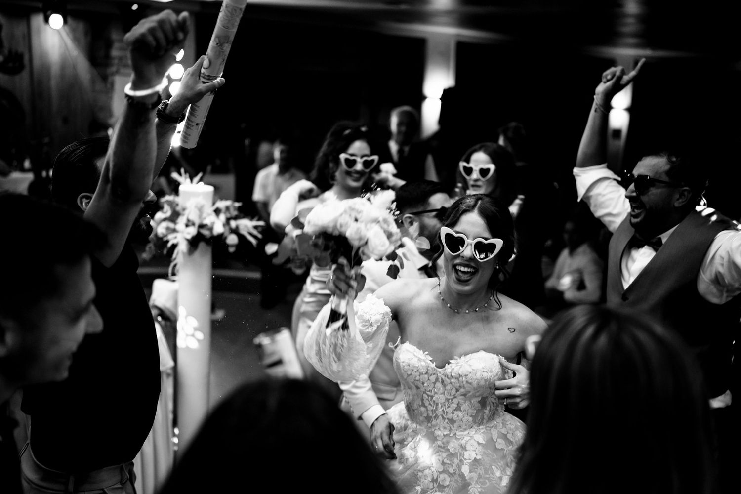 Black and white photo of wedding reception dance floor celebration.