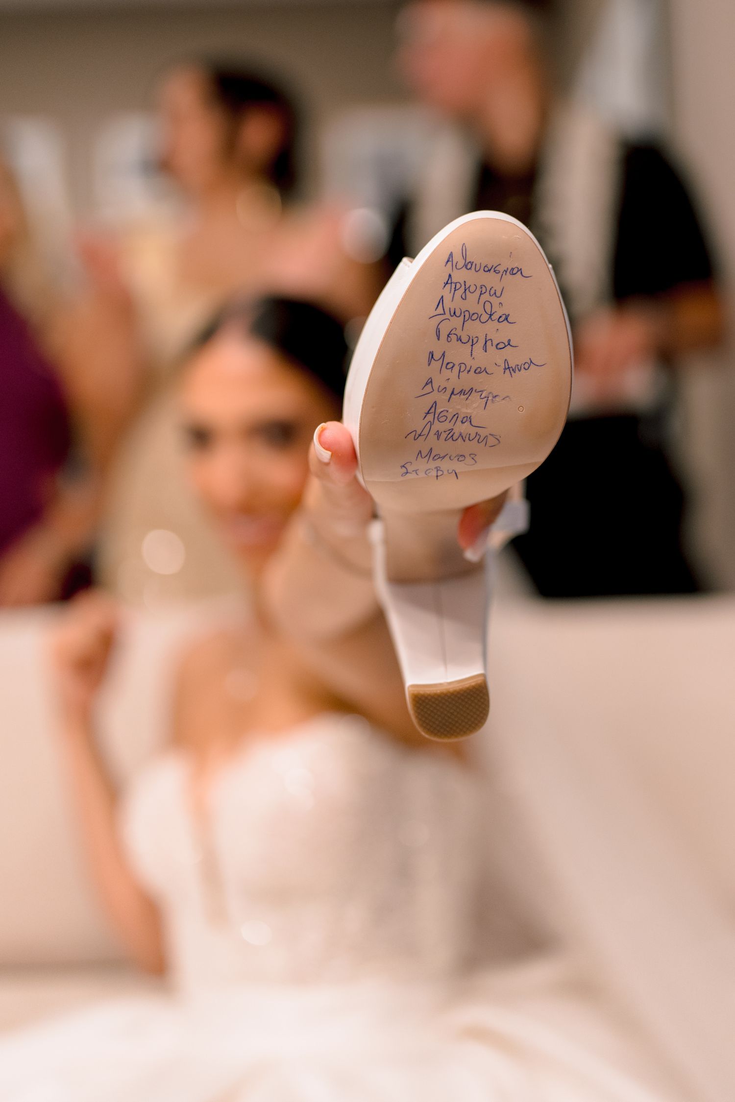 Wedding shoe sole with handwritten blue messages and signatures.