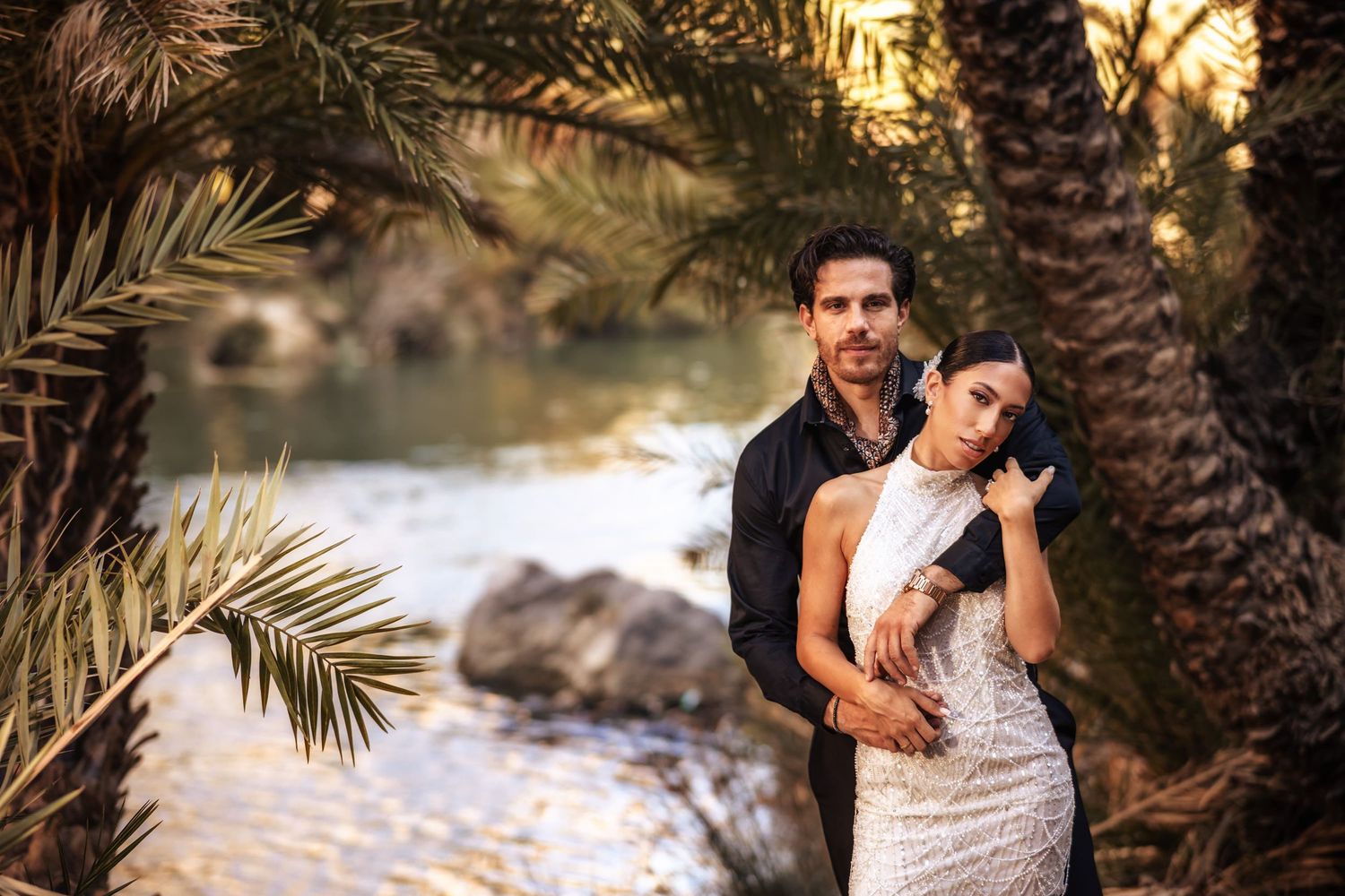 Sunset portrait session among palm trees with warm golden hour lighting.
