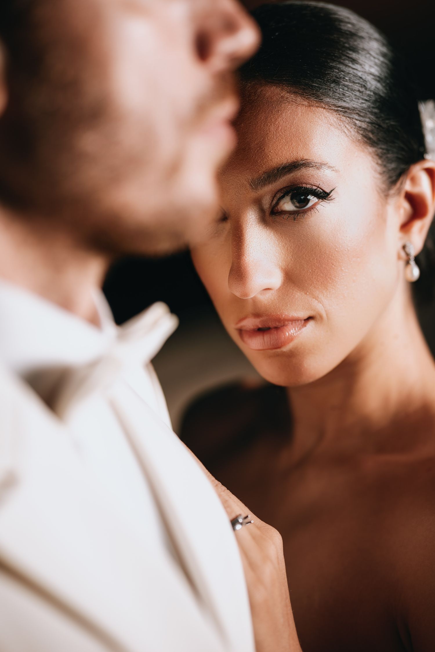 Close-up wedding portraits showing intimate details and expressions in soft lighting.