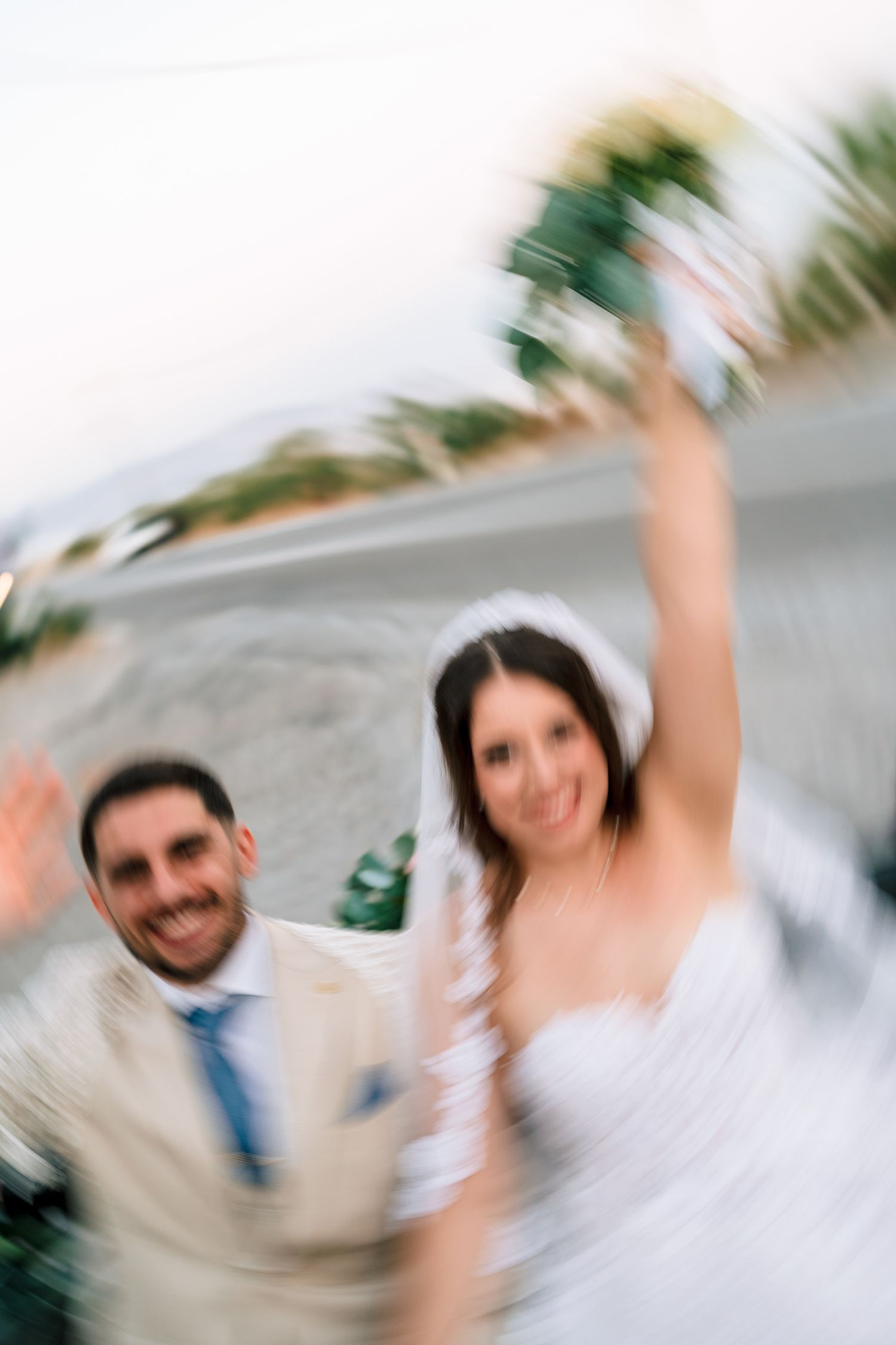 Motion-blurred celebratory moment captured against palm trees and sky.