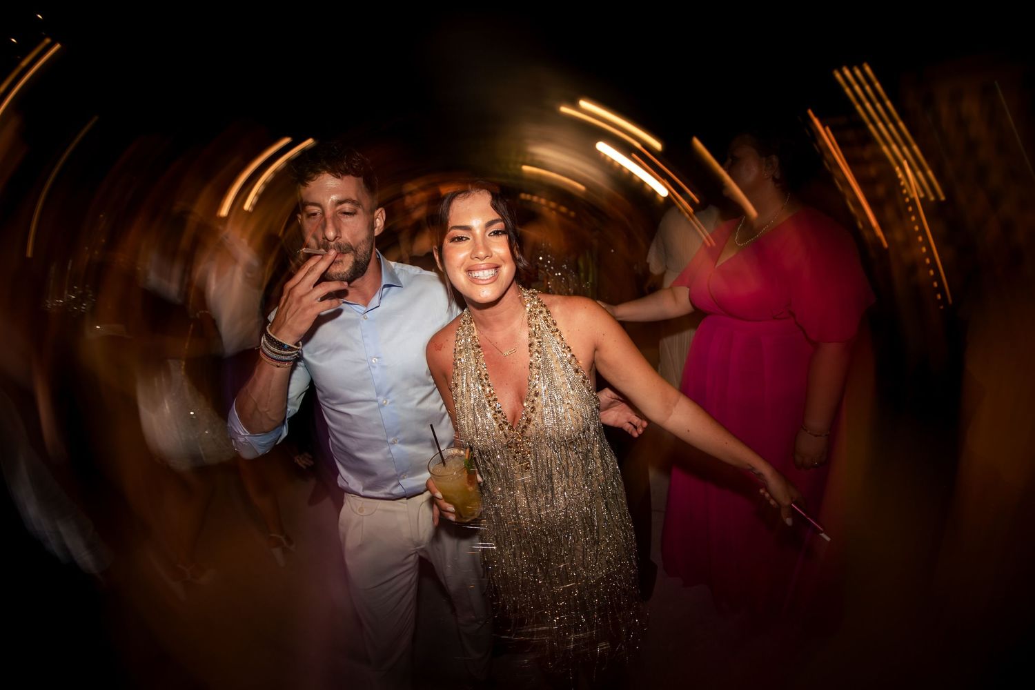 Motion-blurred dance floor scene with celebratory atmosphere and warm lighting.