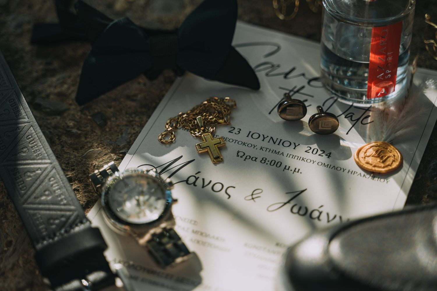 Wedding invitation details and decorative elements laid out on a rustic wooden surface.