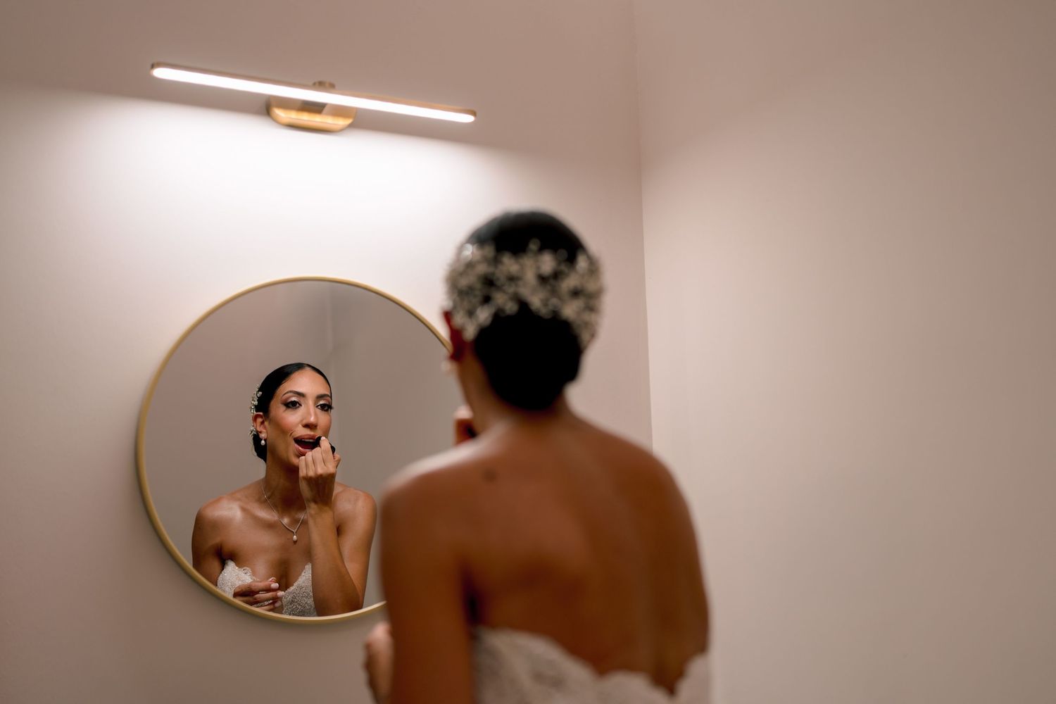 A sequence of oval mirror reflections in a warm-toned room.