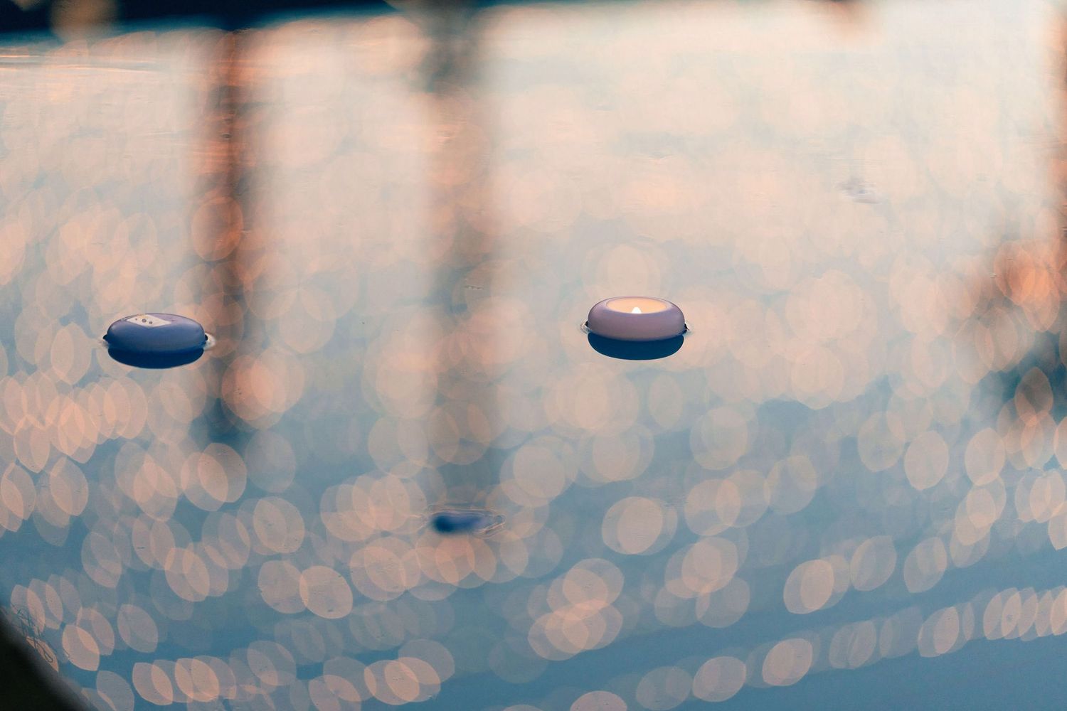 Abstract bokeh lights creating a soft blue blurred background pattern.