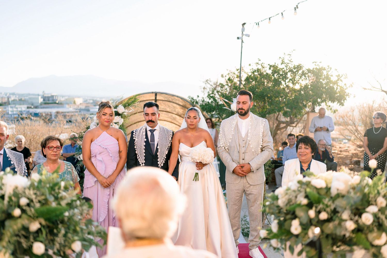 Elegant outdoor wedding setup with floral decorations and mountain views.