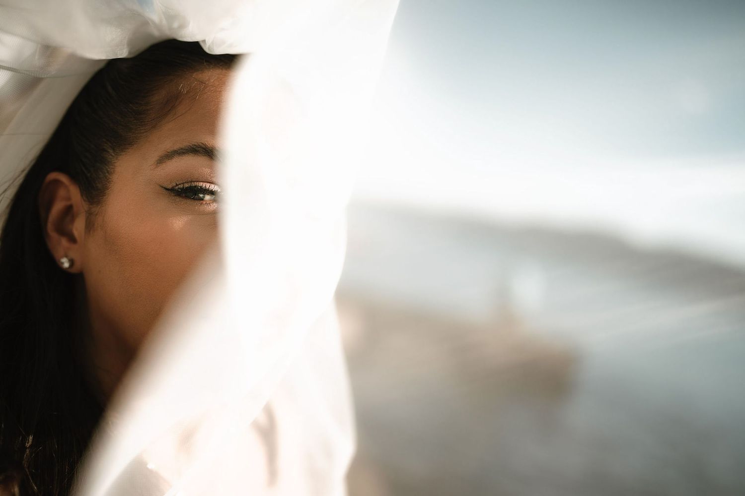 Ethereal close-up wedding photography with soft natural lighting and delicate veil details.