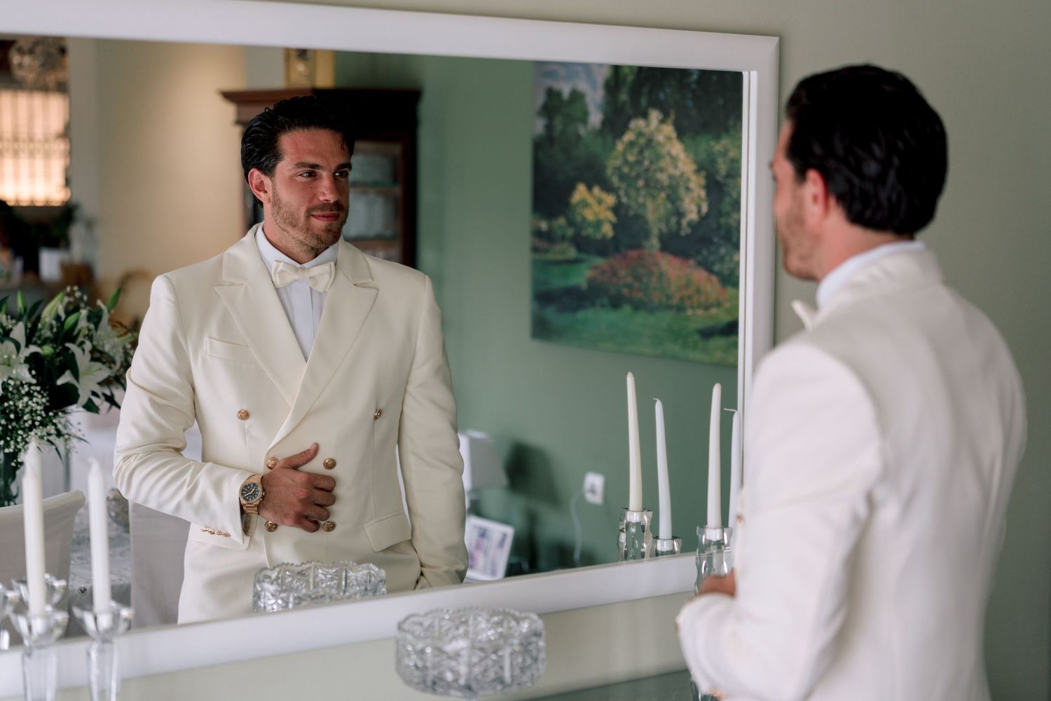 Multiple reflections of person in white suit jacket in mirror.