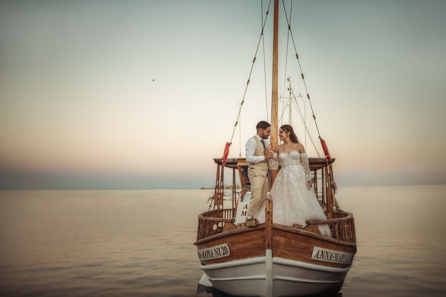 Panoramic view of a classic wooden boat floating on peaceful Mediterranean waters.