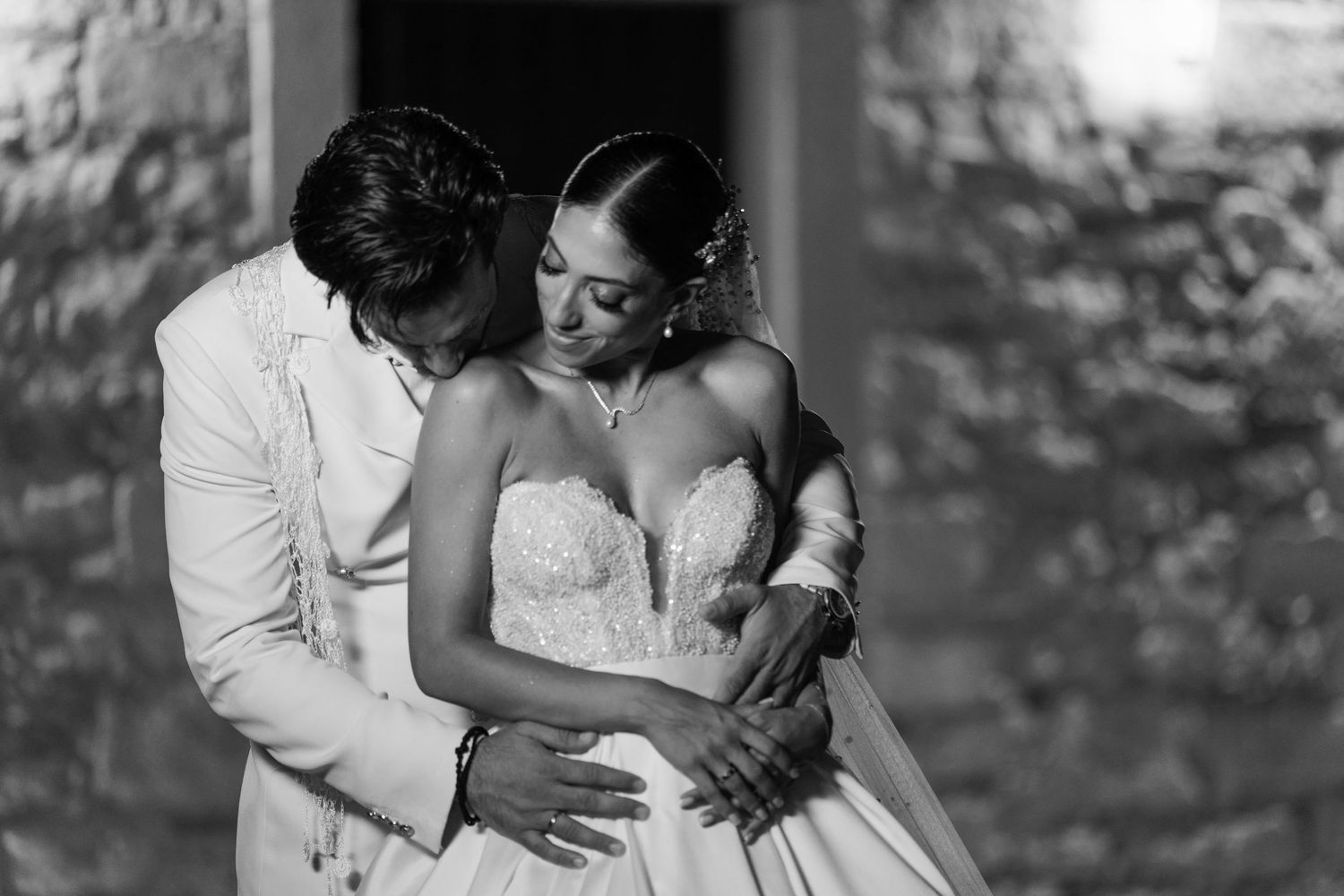 Black and white wedding portrait showing an intimate embrace.