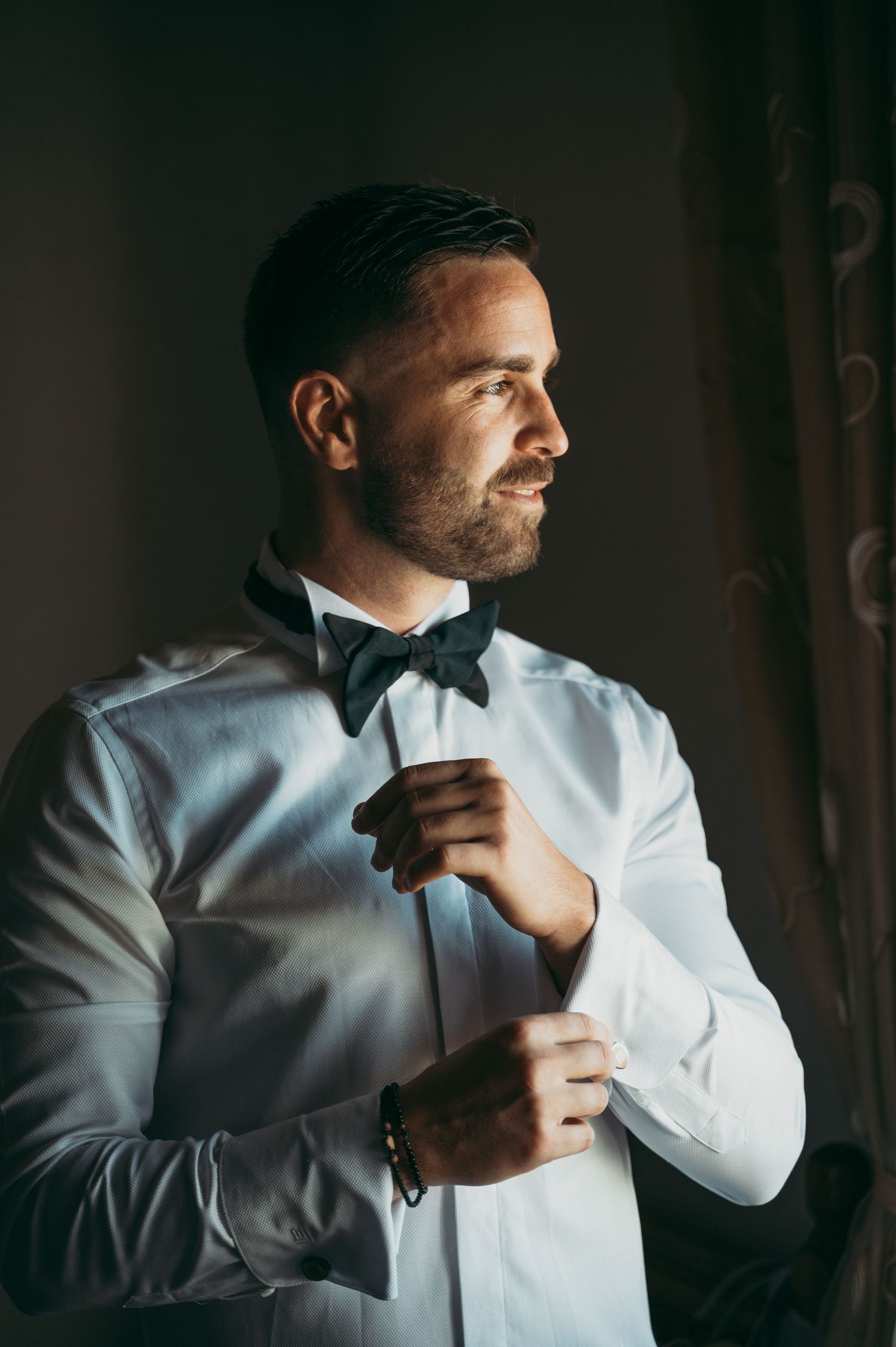 A sequence of photos showing a man in white dress shirt adjusting his collar.
