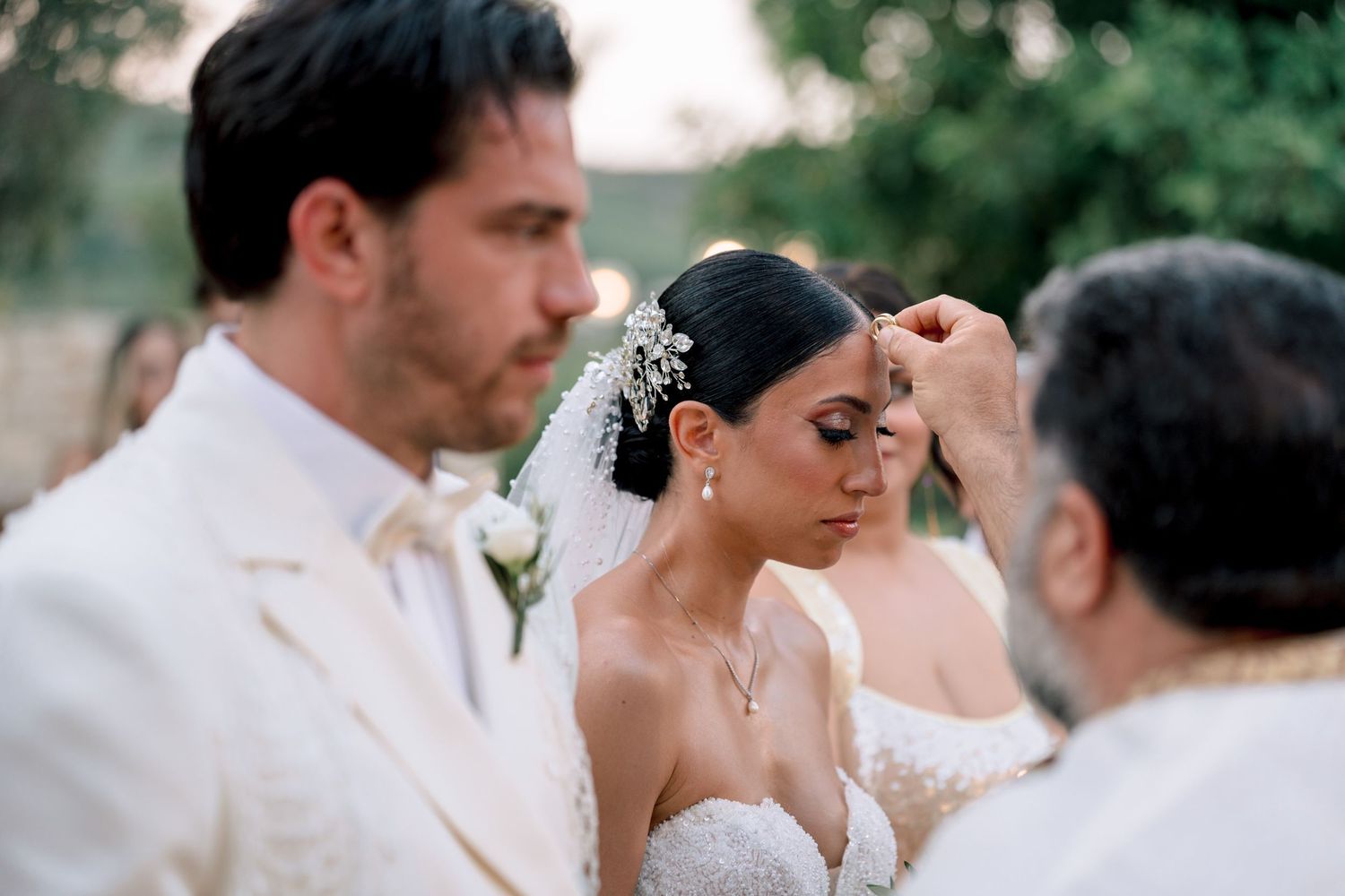Intimate wedding moment captured during outdoor celebration with guests.