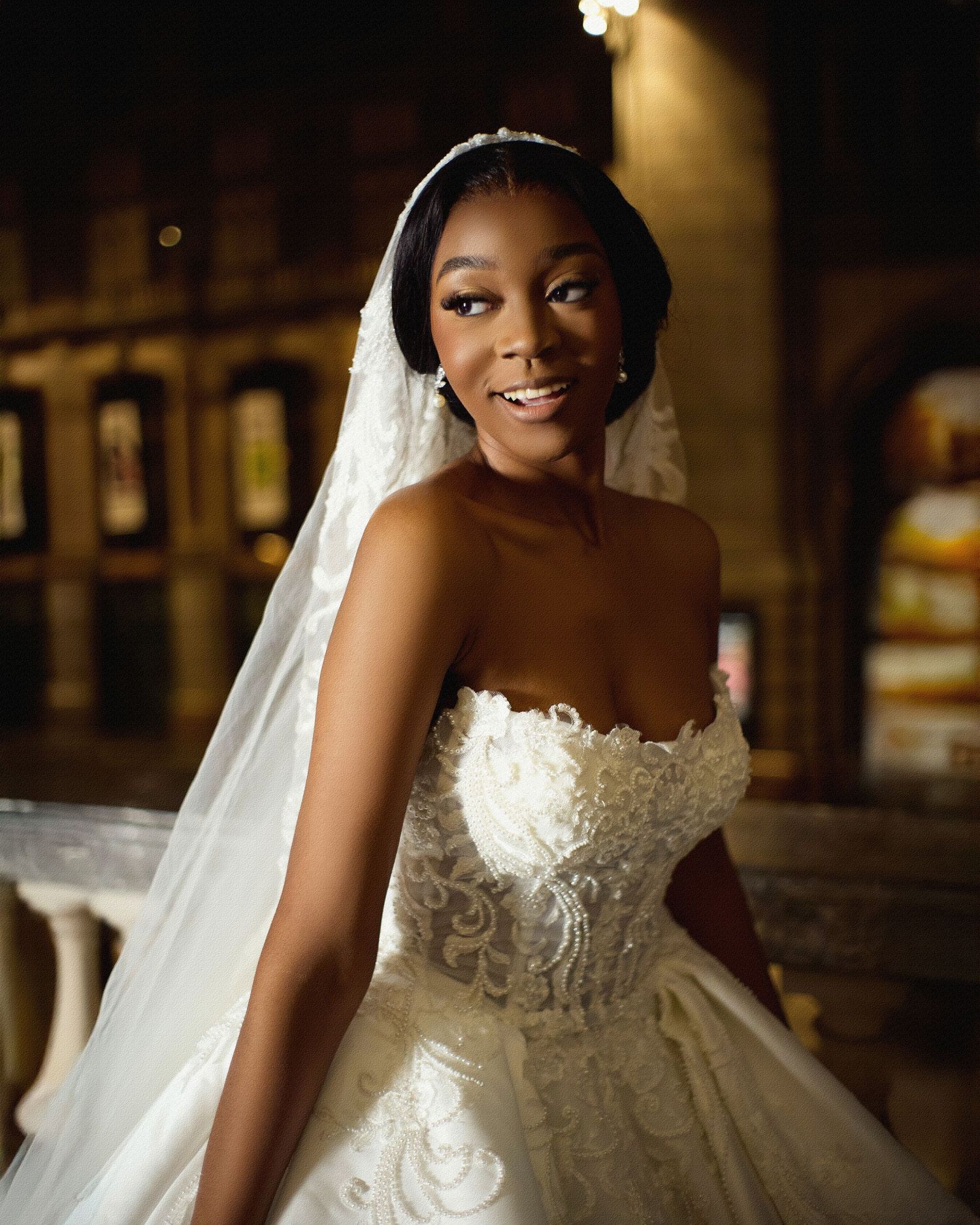 An elegant bridal portrait showcases a stunning white lace wedding gown with sweetheart neckline.