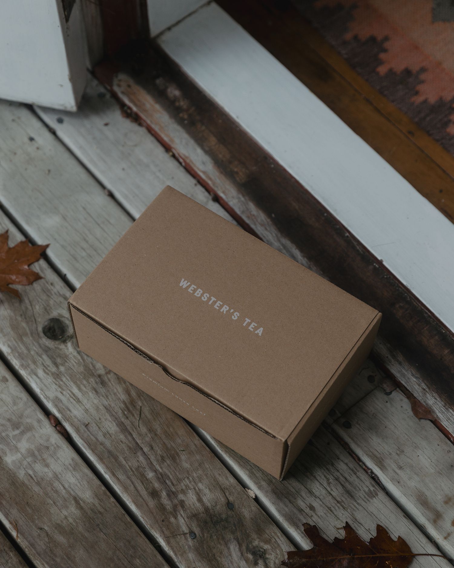 Brown cardboard box on weathered wooden surface.