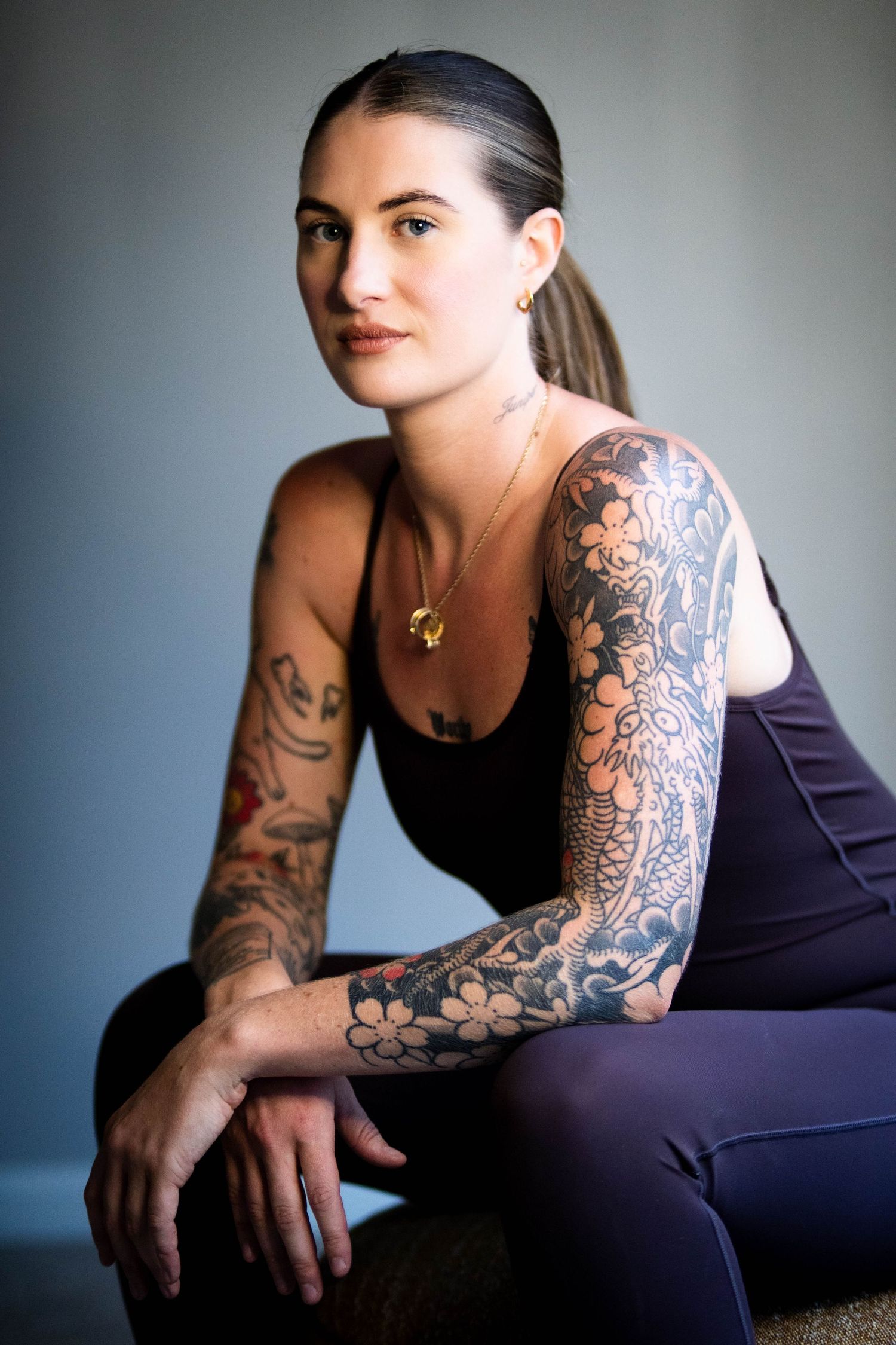 Artistic portrait series showcasing detailed arm sleeve tattoo against dark background.