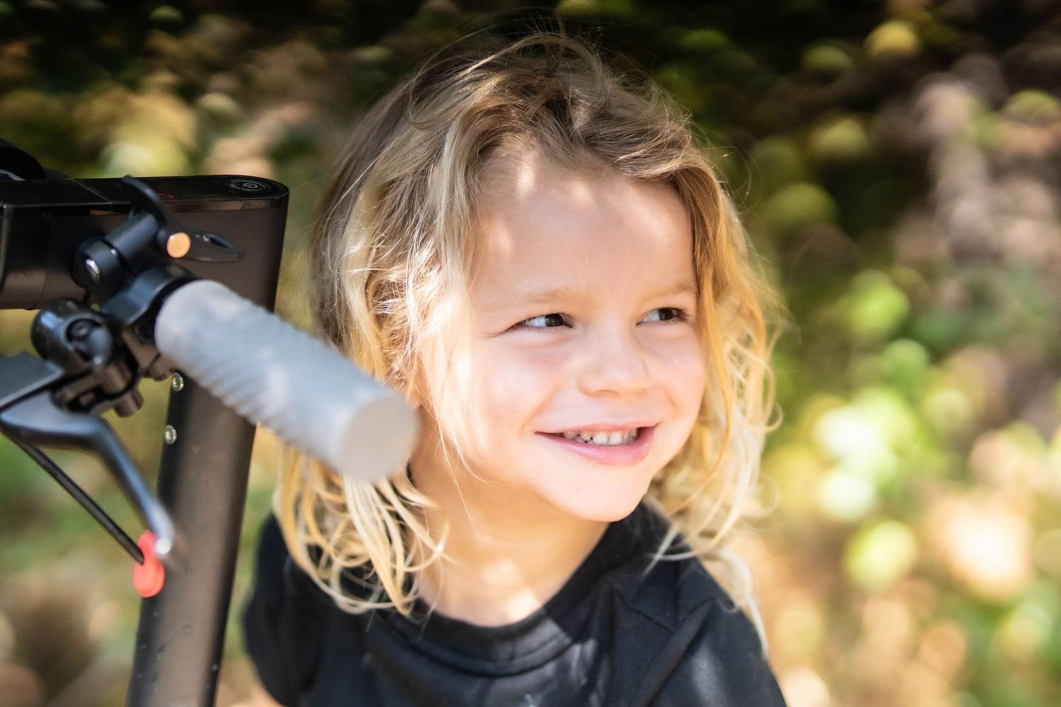 A playful outdoor portrait showing joyful expressions in natural lighting.