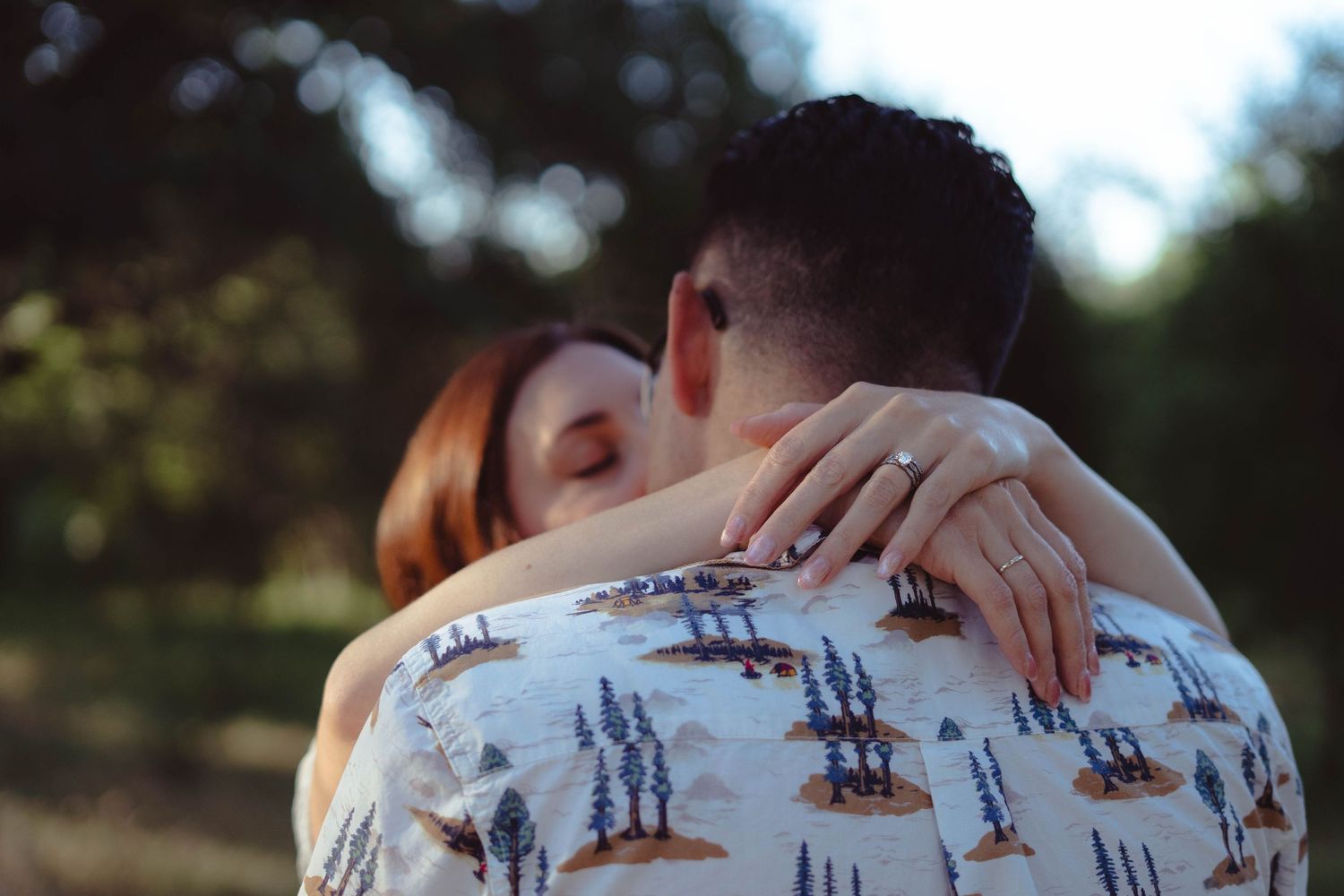 Close-up shots of a couple embracing in natural outdoor lighting.