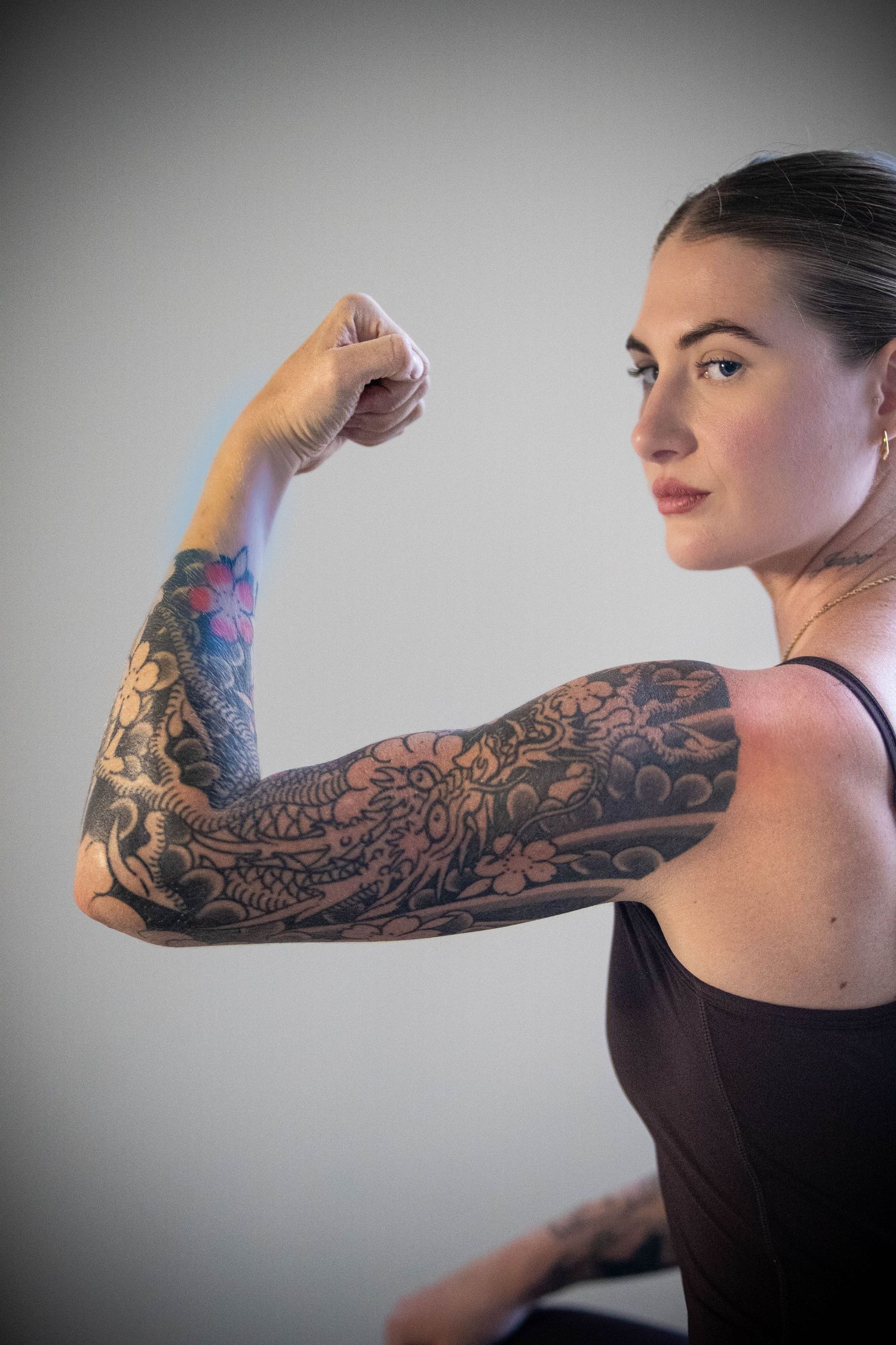Sequential photos demonstrating arm movement with detailed sleeve tattoo design.