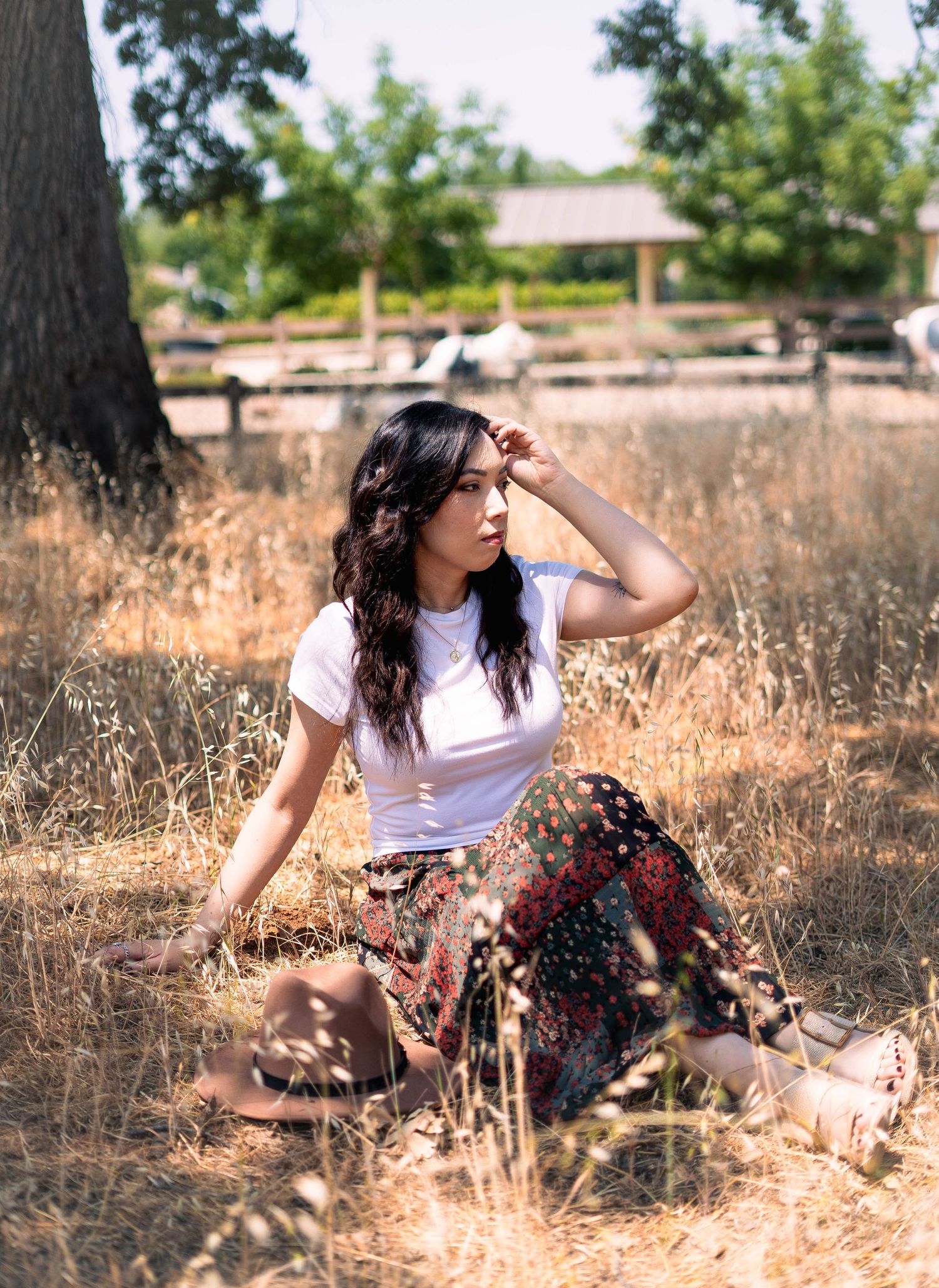 Summer outdoor photoshoot in dry grass field with vintage style clothing.