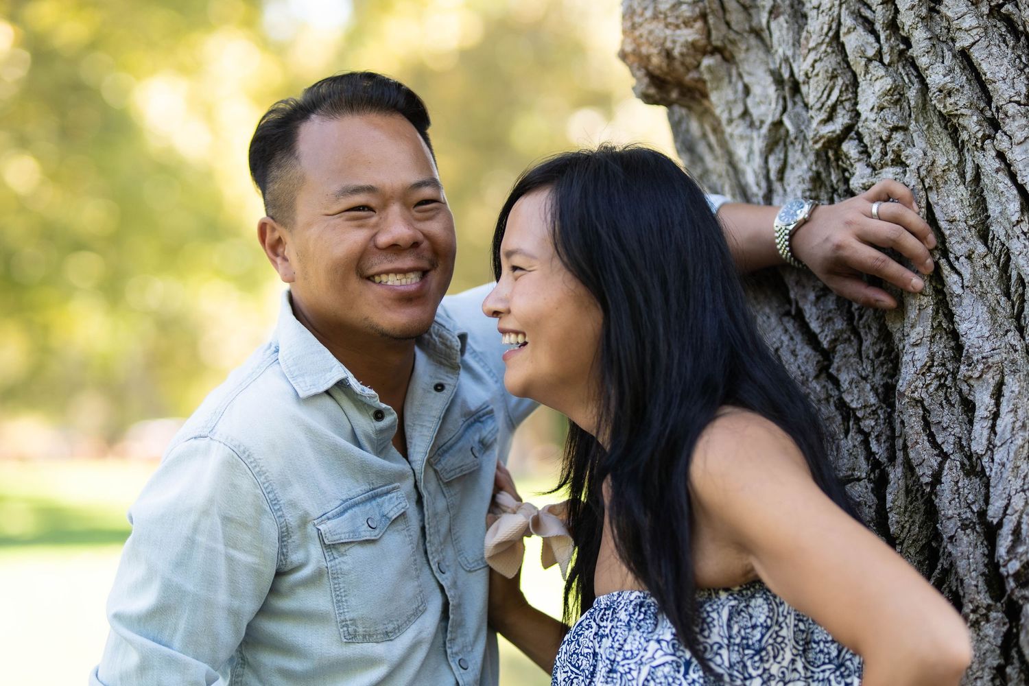 Romantic couple photos taken against rustic tree bark background.