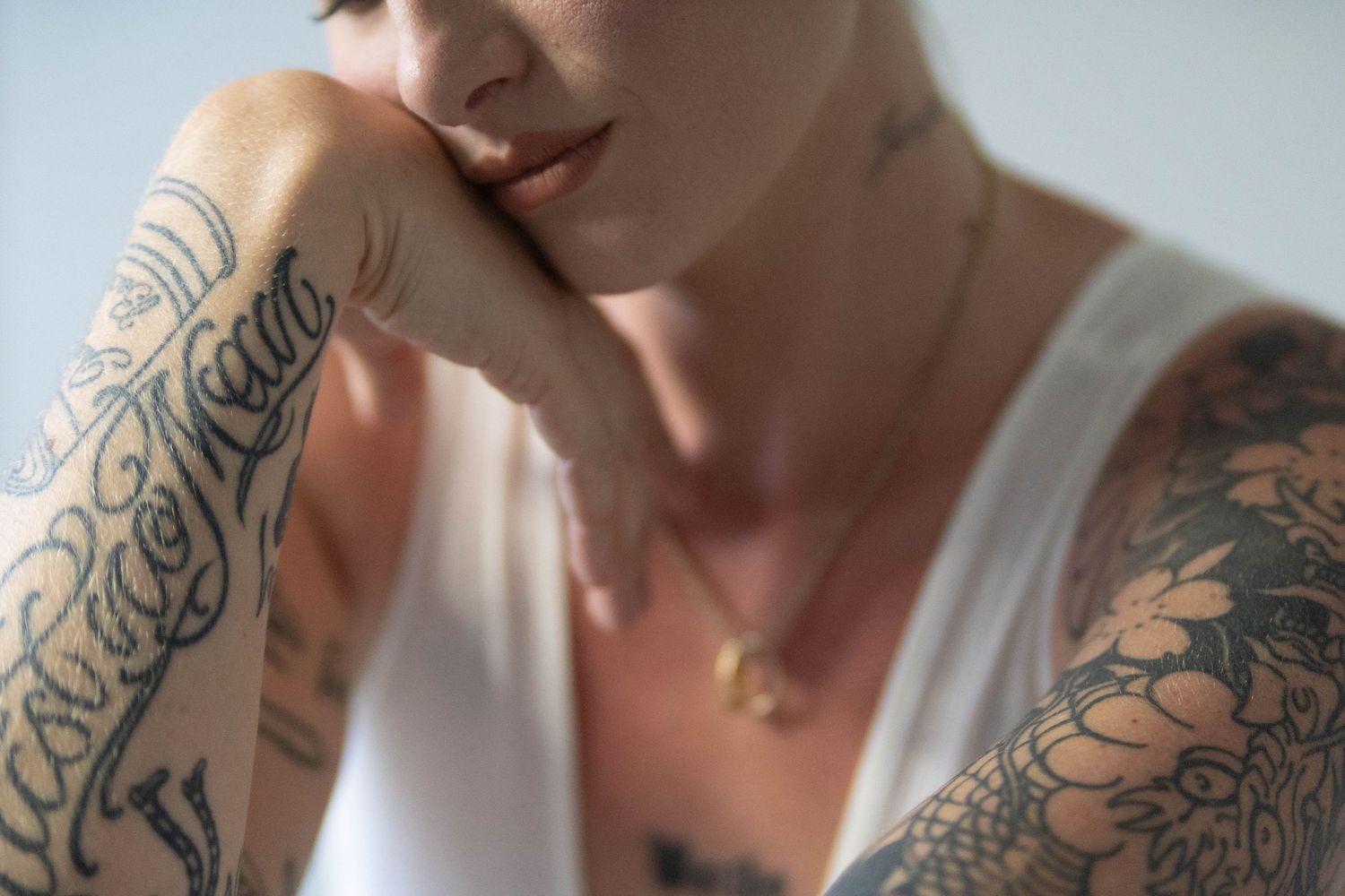 Artistic shots focusing on intricate floral tattoo designs on shoulder and arm.