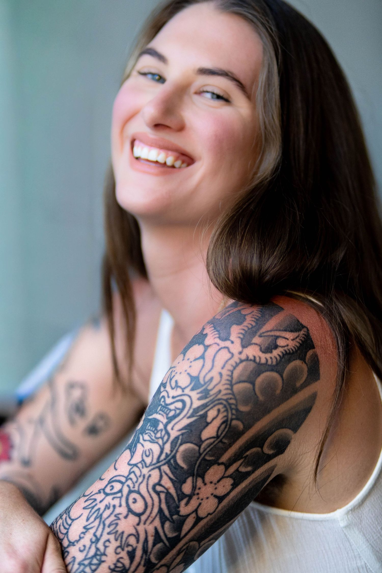 Series of artistic portraits showcasing intricate sleeve tattoo designs.