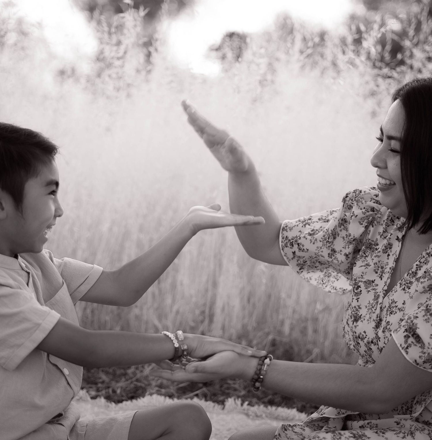 A black and white photo captures a playful moment between parent and child.