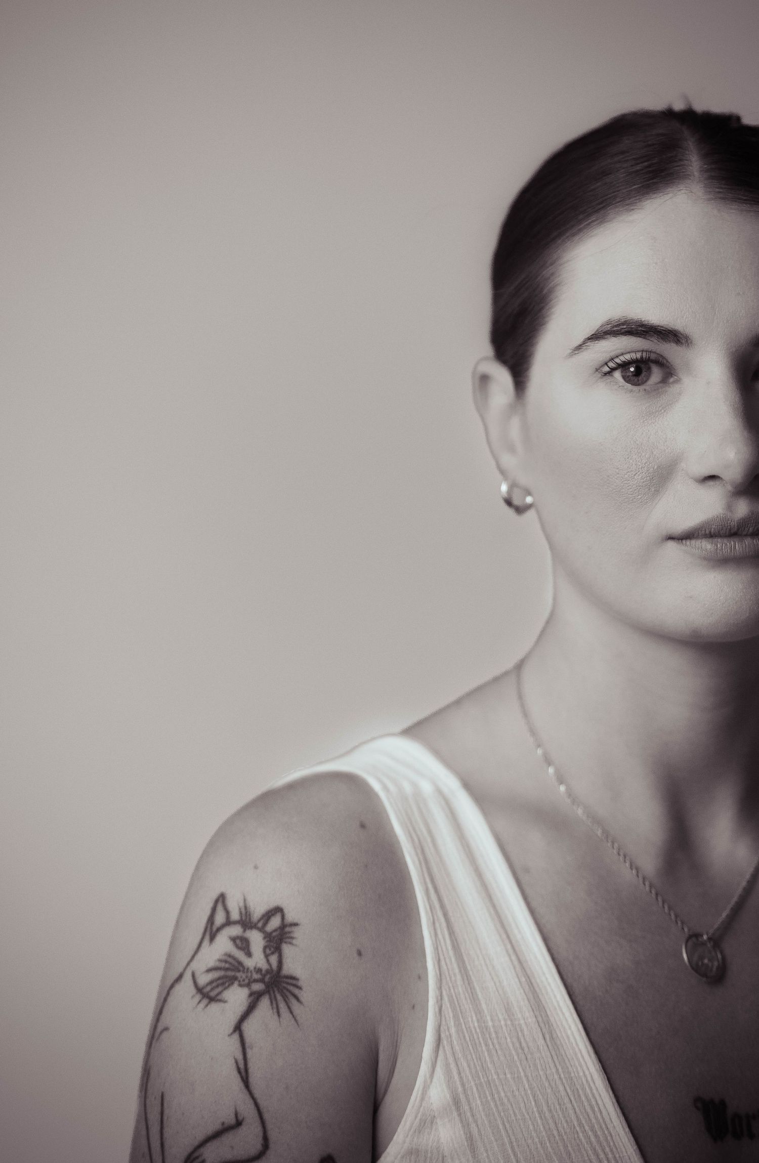 Artistic black and white portrait sequence showing profile and tattoo details.