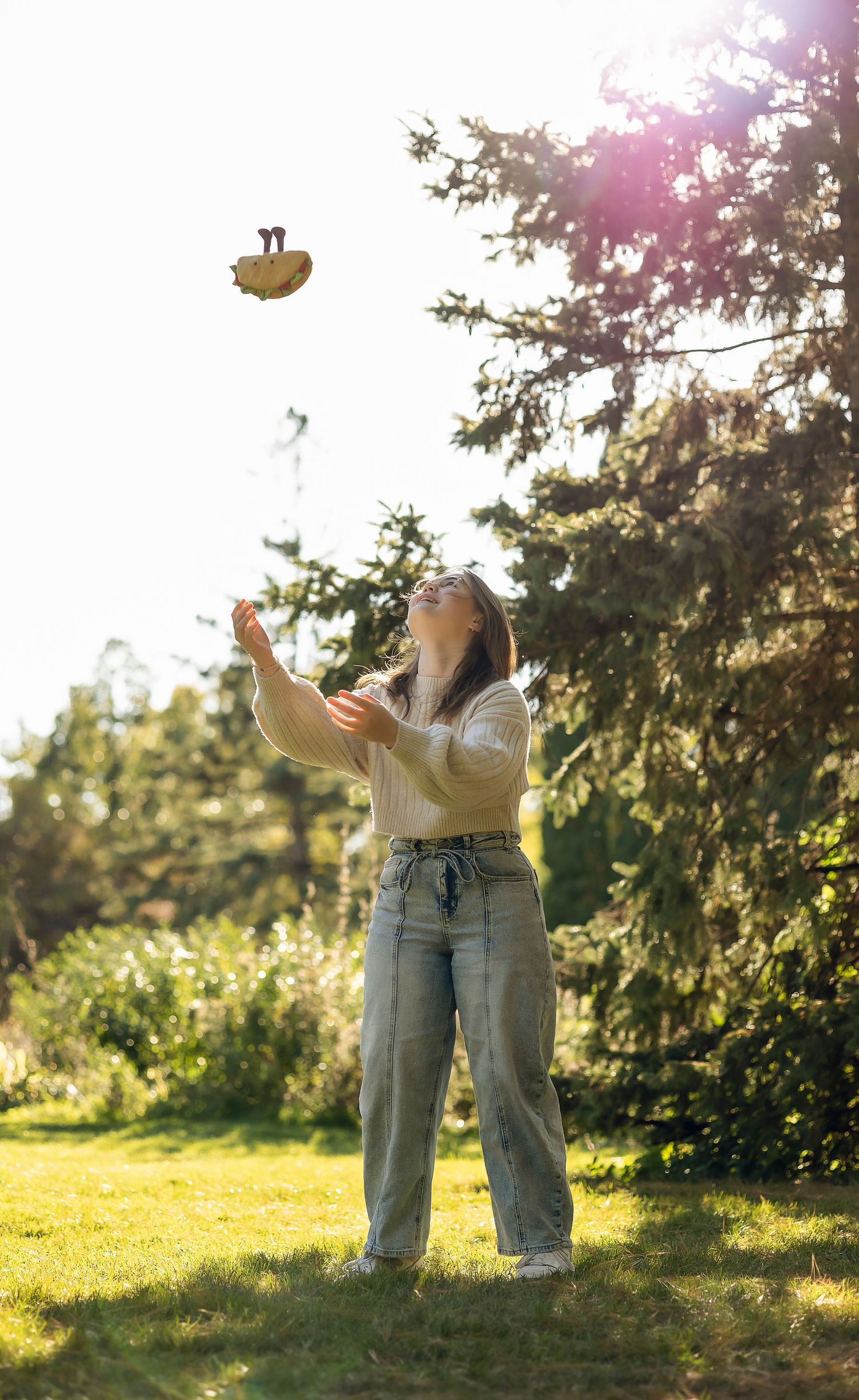 Girl throwing a stuffed taco in the air