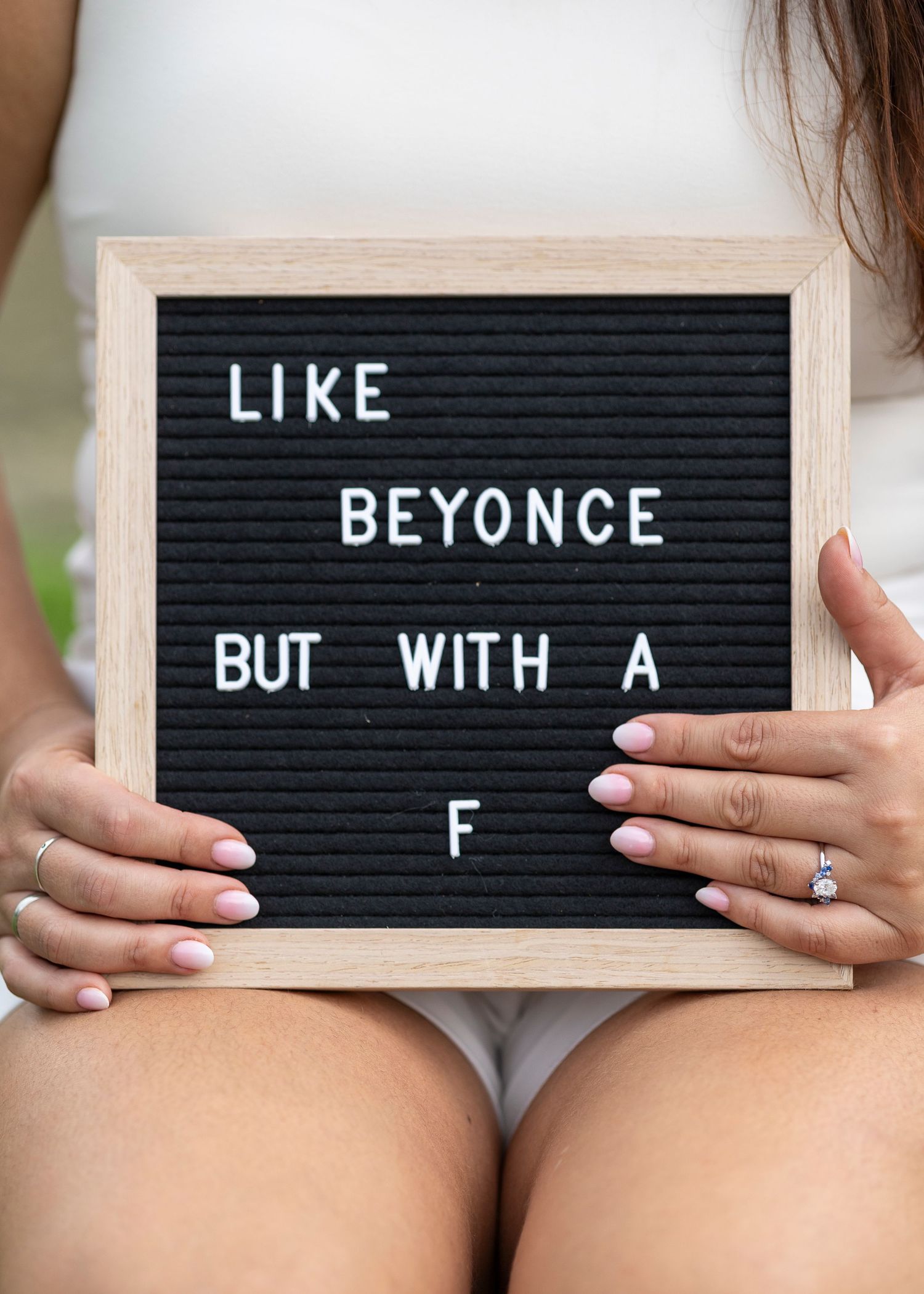 Girl holding a sign that say like beyonce but with a F