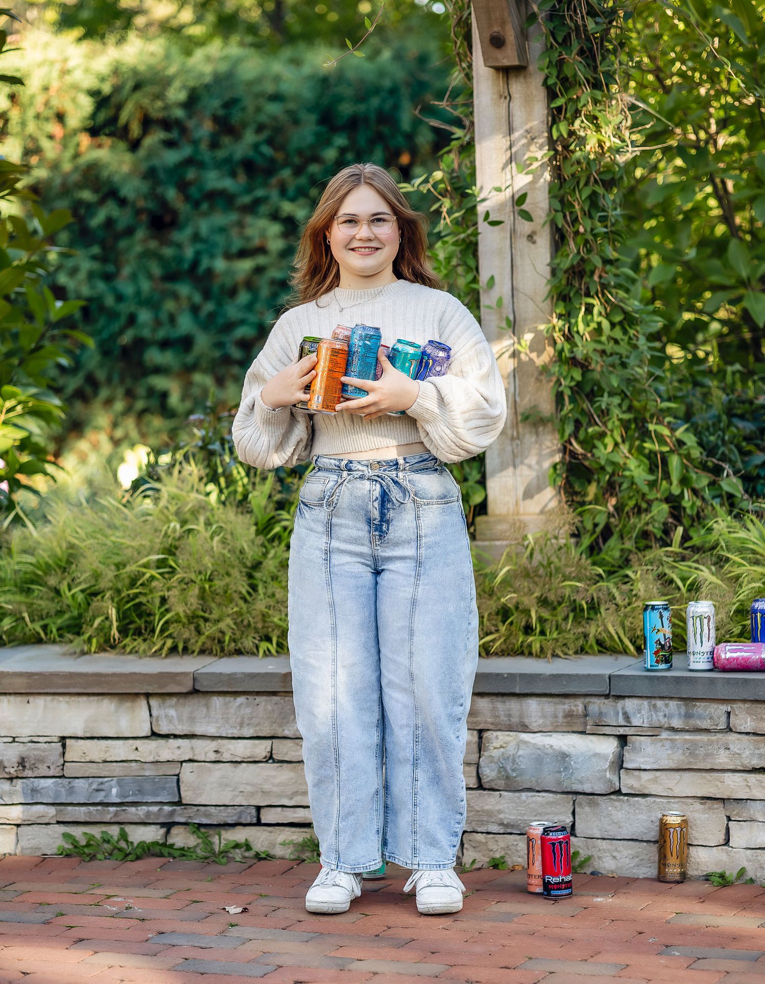 Girl hugging empty Monster Energy drink cans