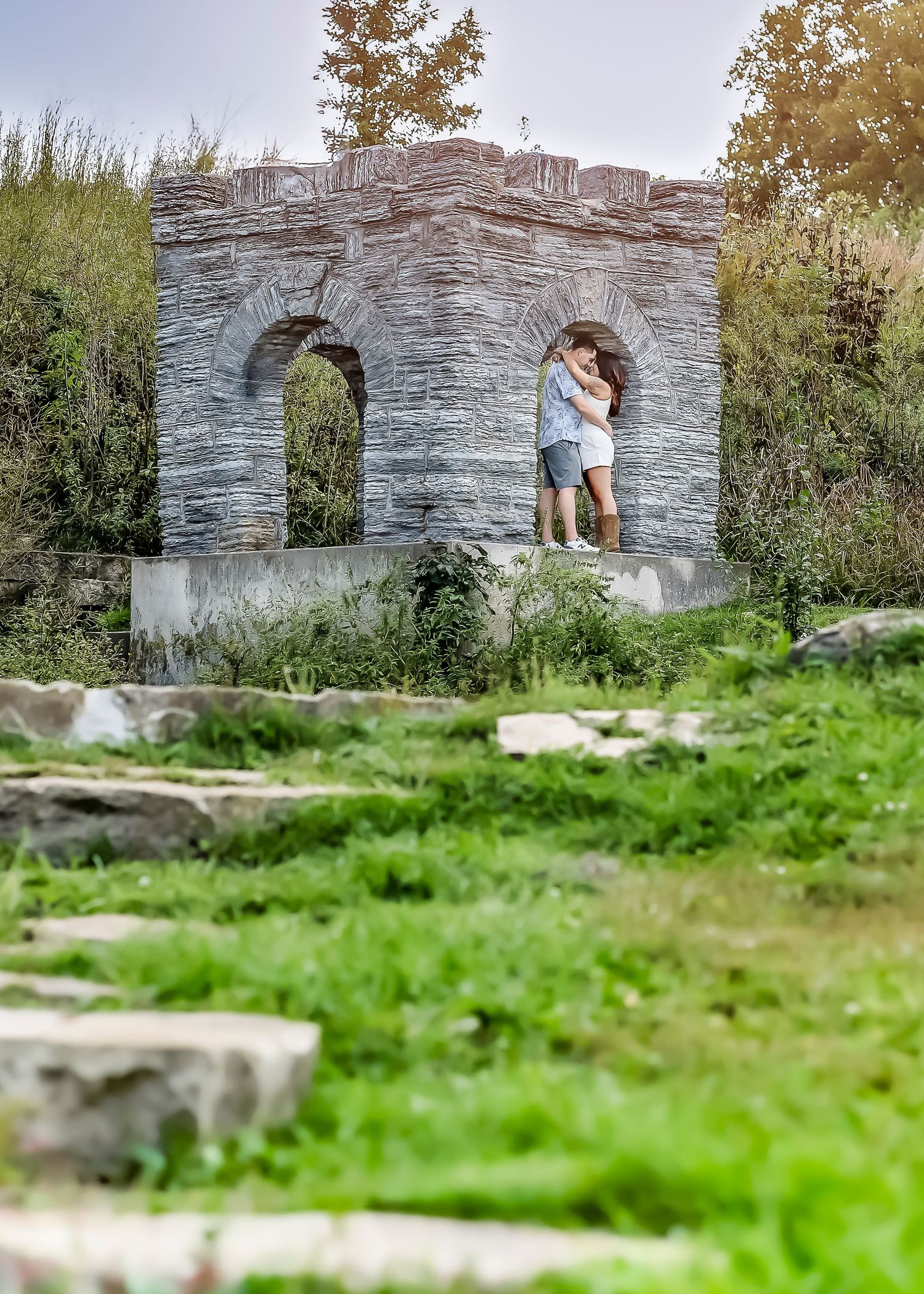 Woman and man kissing in a stone structure