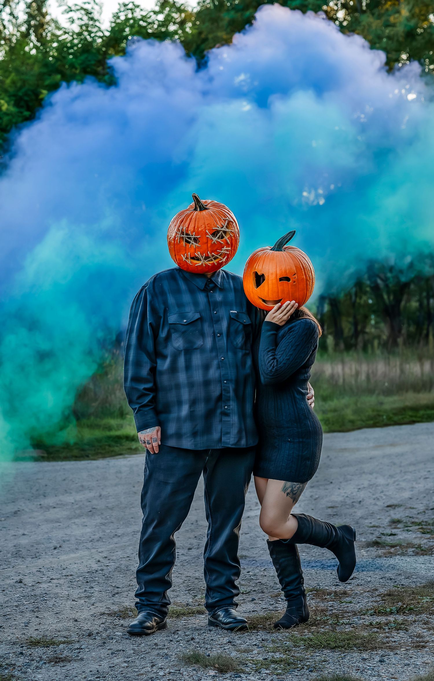 Pumpkin head couple in front of smokey background