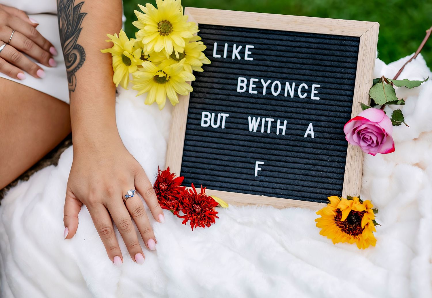 Girls hand with engagement ring next to sign that says like beyonce but with a F