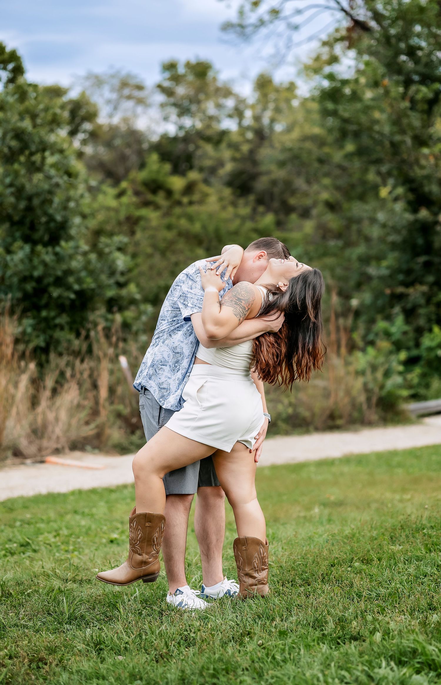 Man dancing and hugging a girl in cowgirl boots