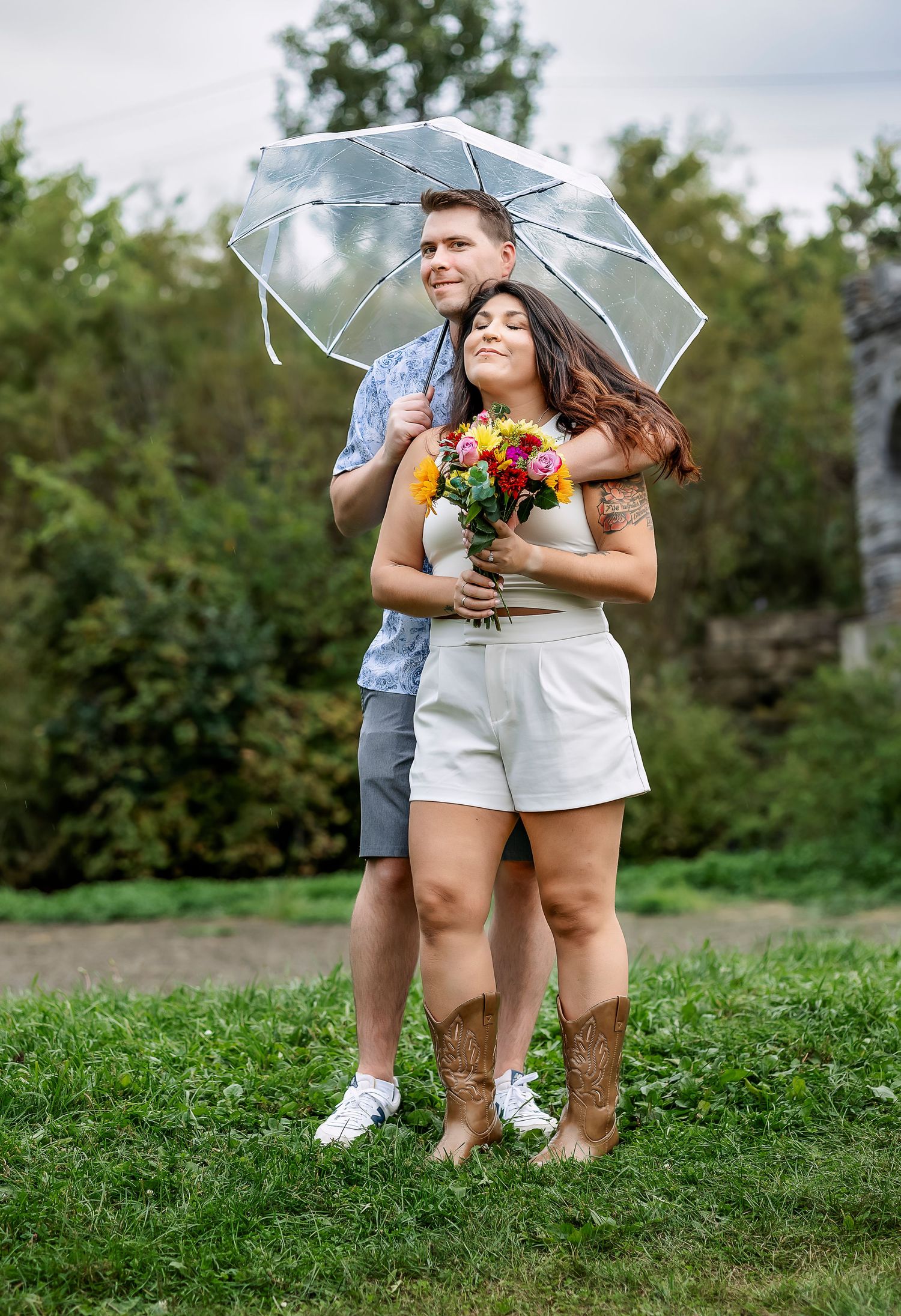 Man and woman hugging under clear umbrella