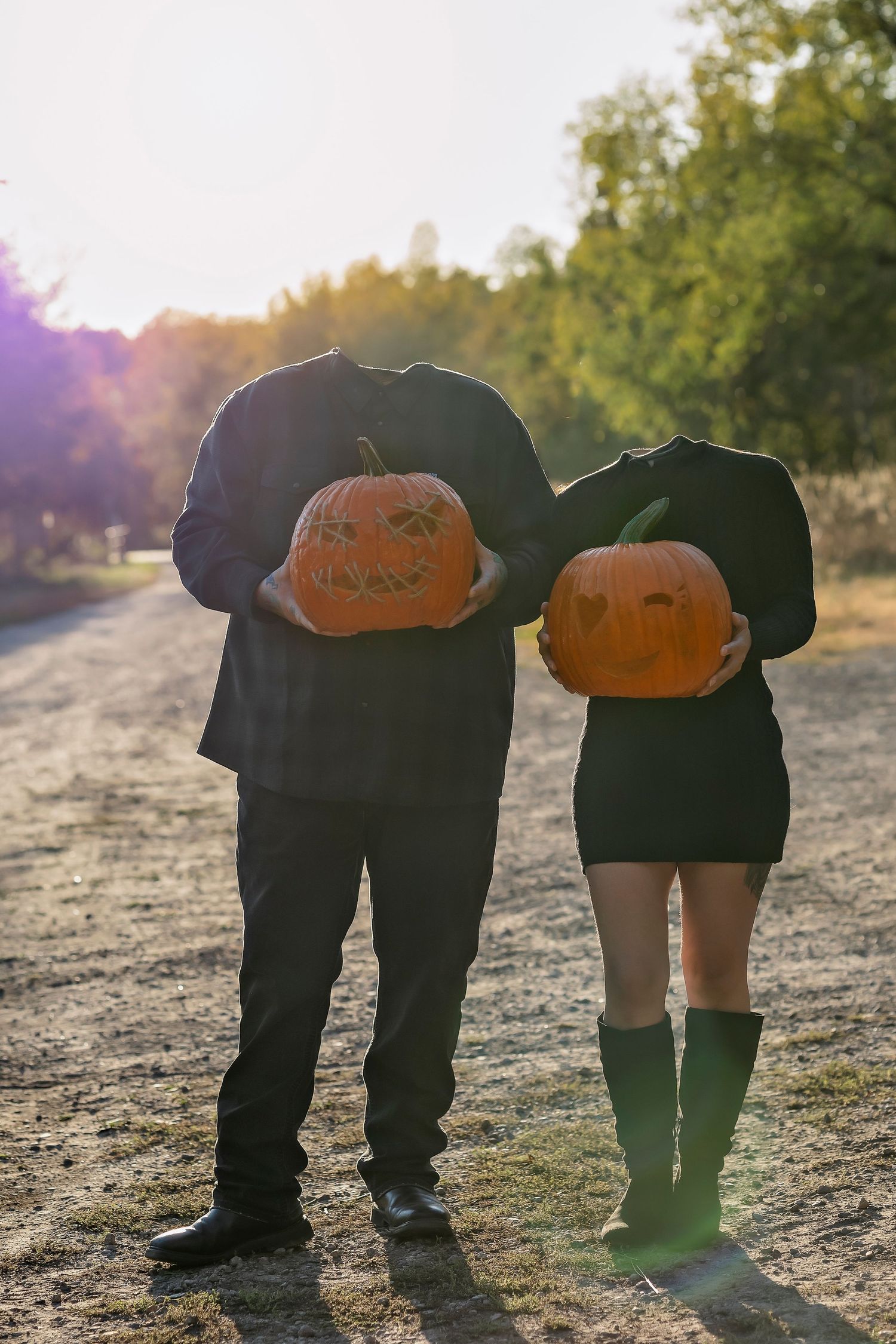 couple holding their own pumpkin head