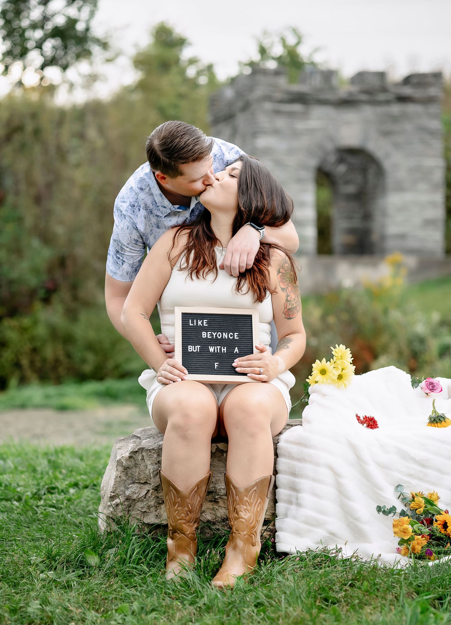 Man leaning over girls shoulder to kiss her