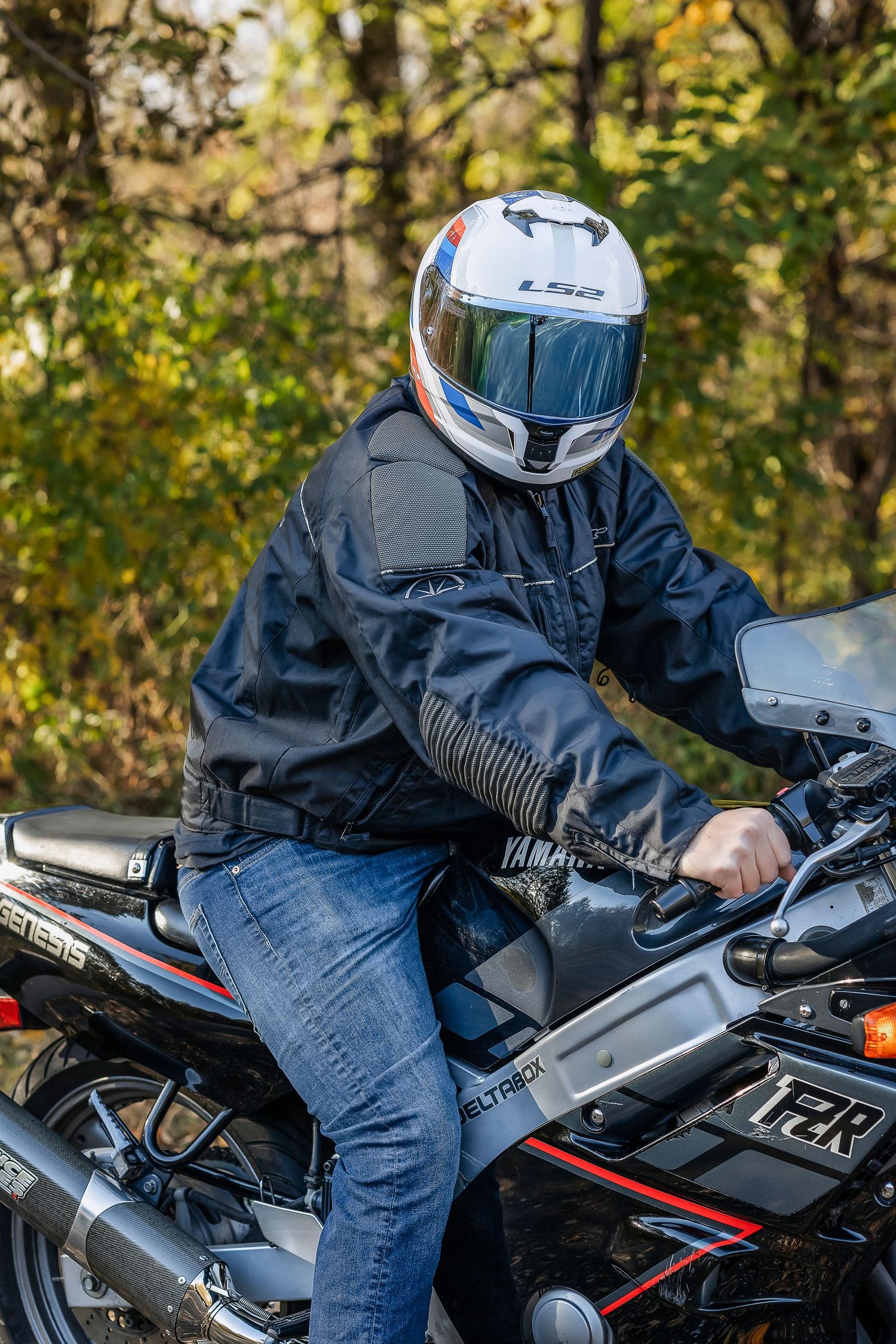 Young motorcyclist wearing a white helmet