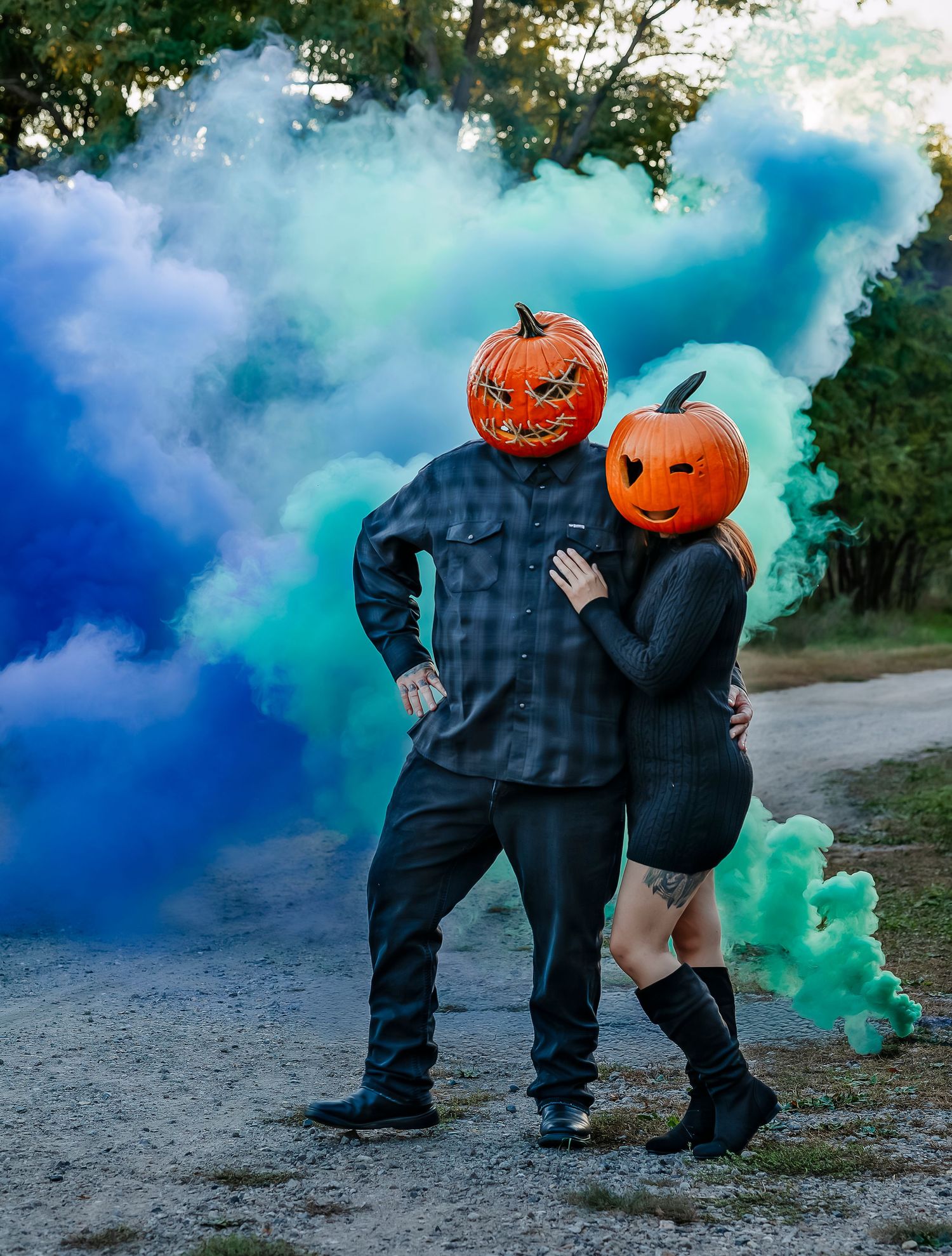 Couple flirting in front of green and blue smoke