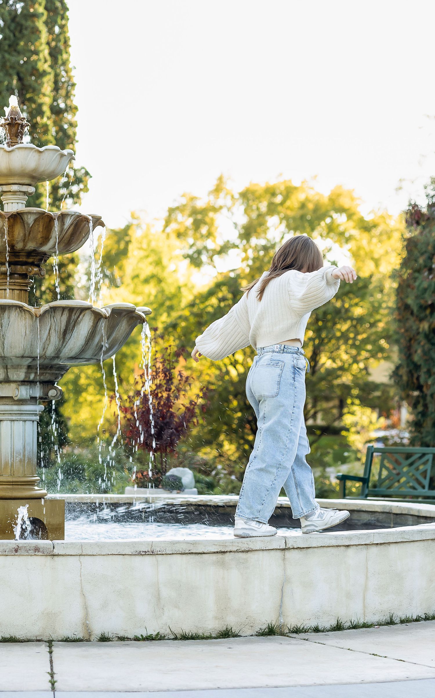 Senior girl walking the water fountain