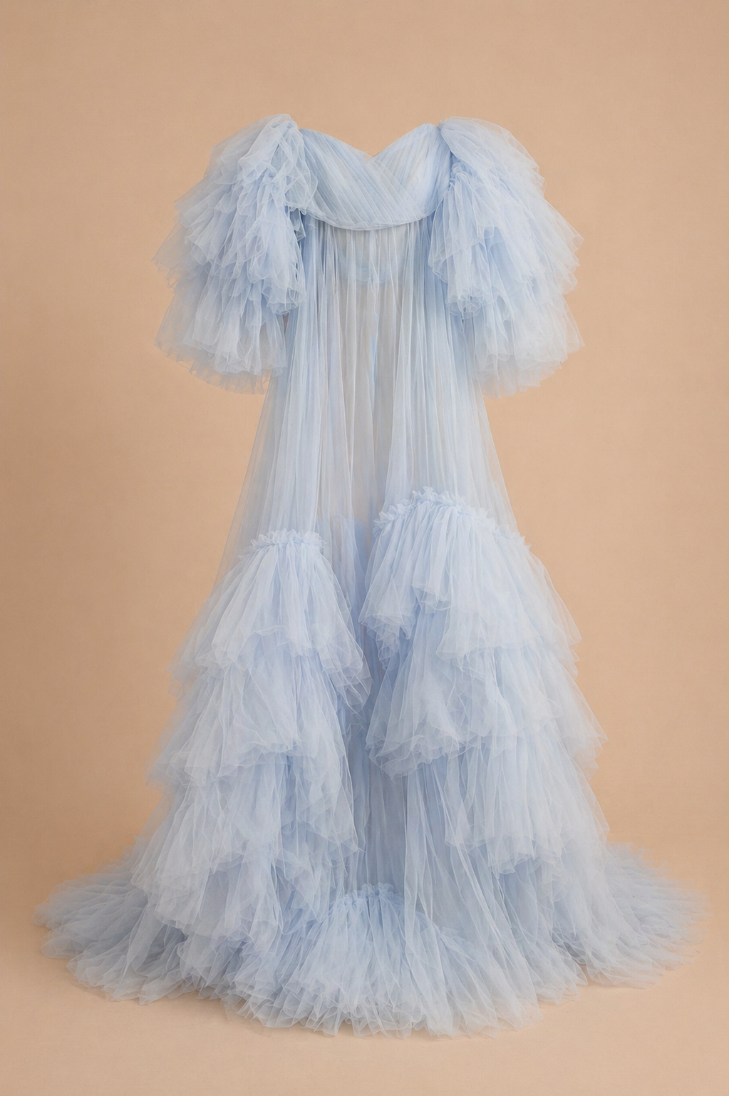 Light blue ruffled tulle maternity gown with puff sleeves and tiered skirt.