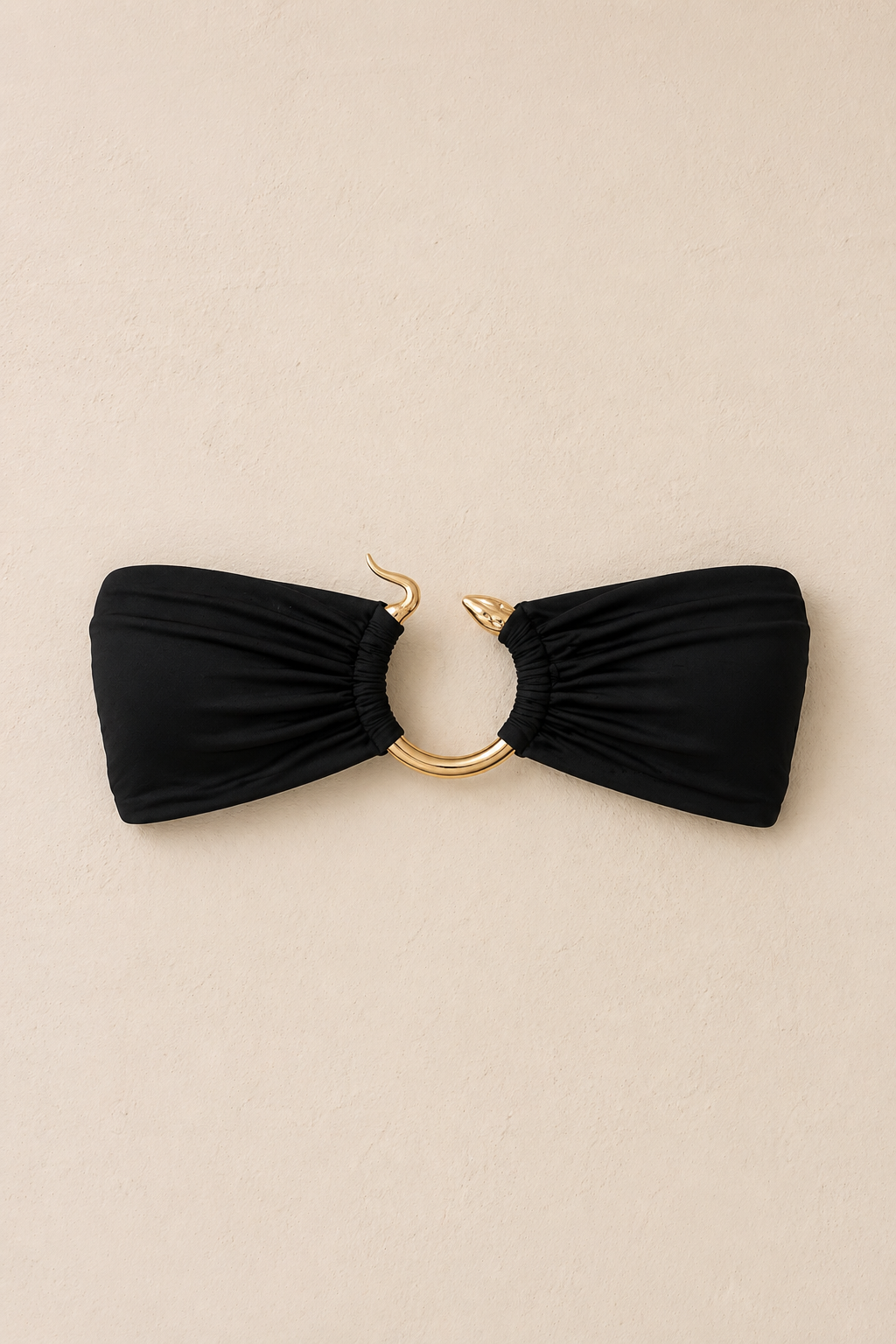 Black bandeau bikini top with gold ring and hook hardware detail .