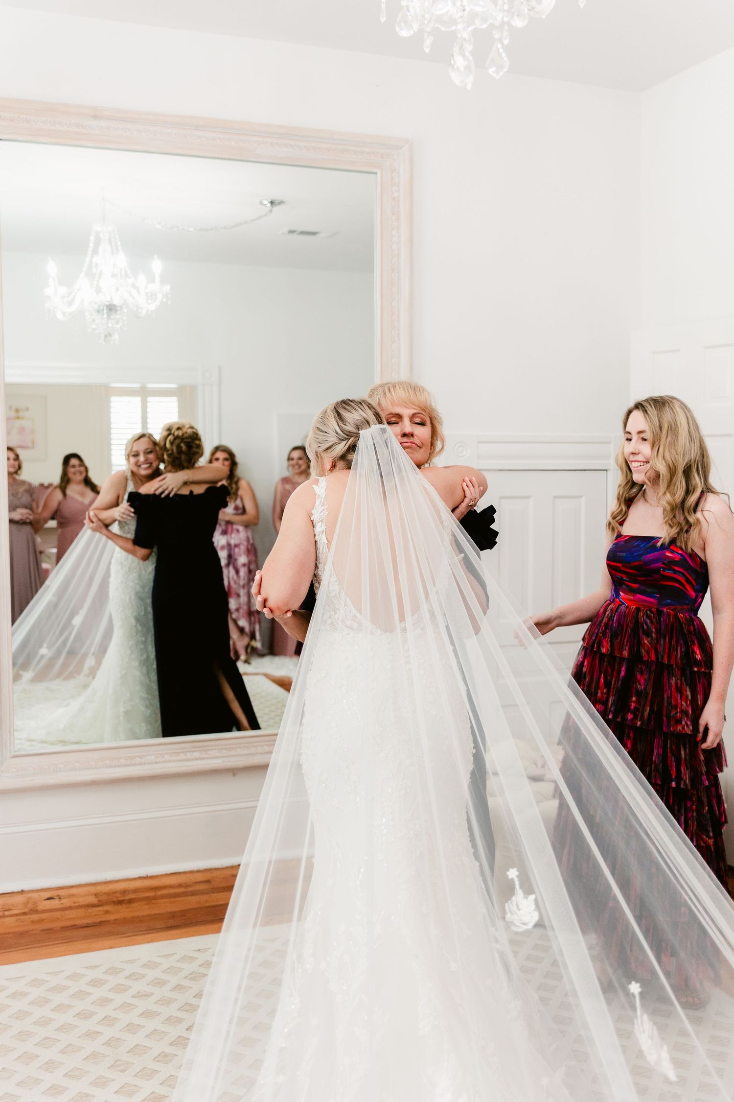 A sequence of reflective mirror images shows a bride in a flowing white gown and veil during a wedding preparation.