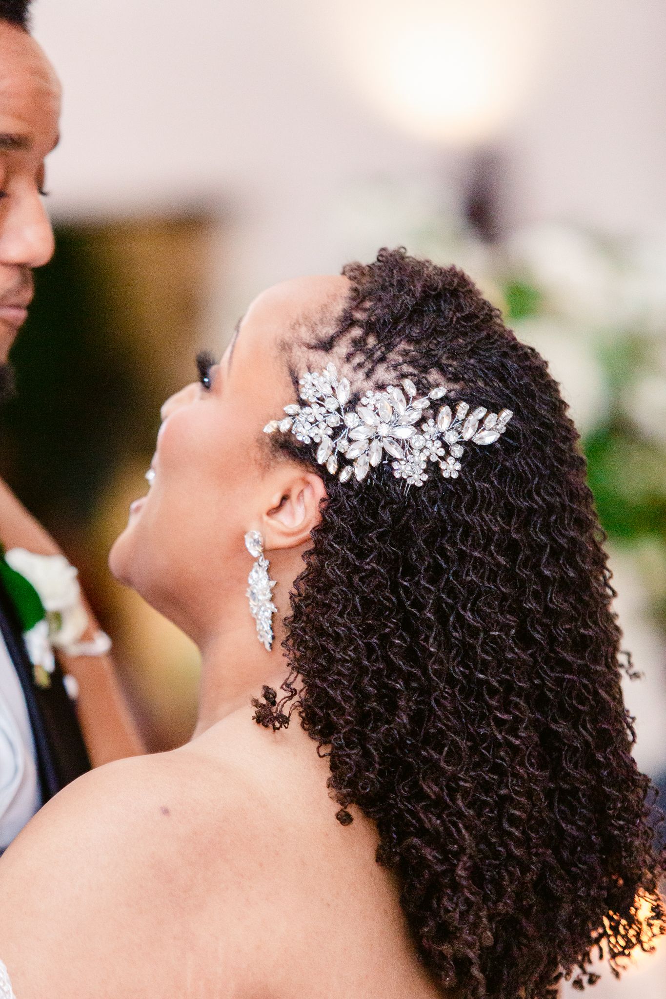 Close-up shots of elegant bridal hairstyle with sparkling crystal hair accessories.