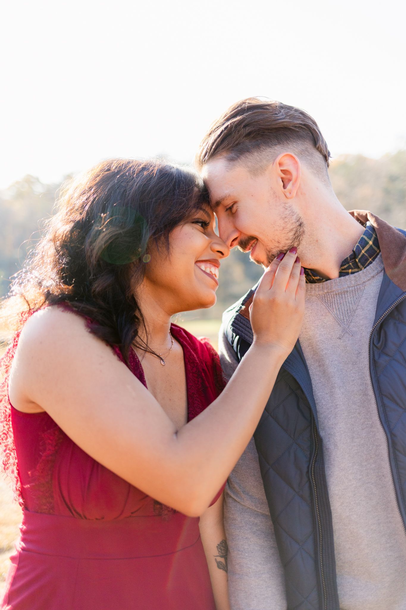 A romantic couple shares tender moments in a series of four intimate poses against golden sunlight.