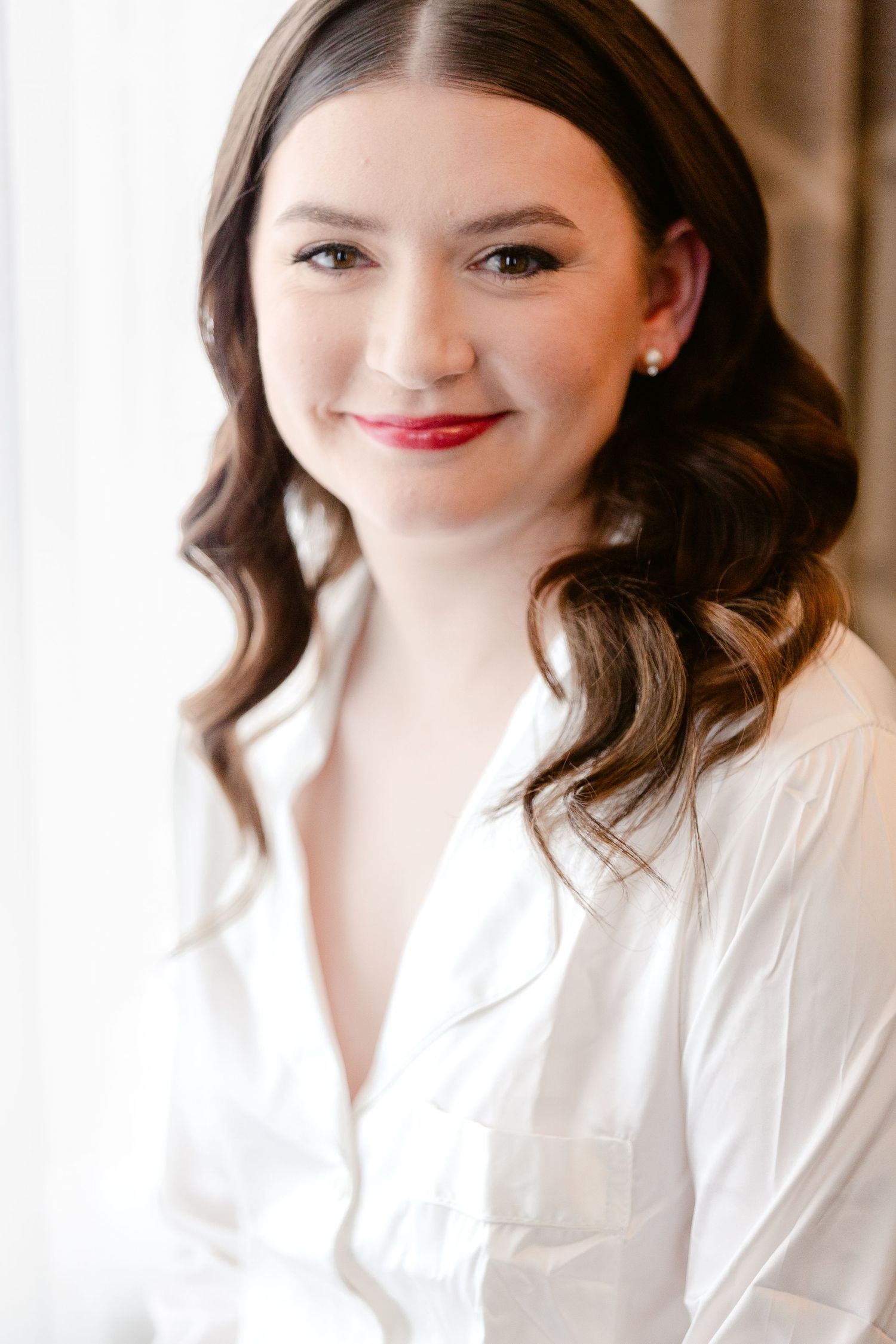 A sequence of bridal preparation photos showing someone in a white robe with styled dark wavy hair.